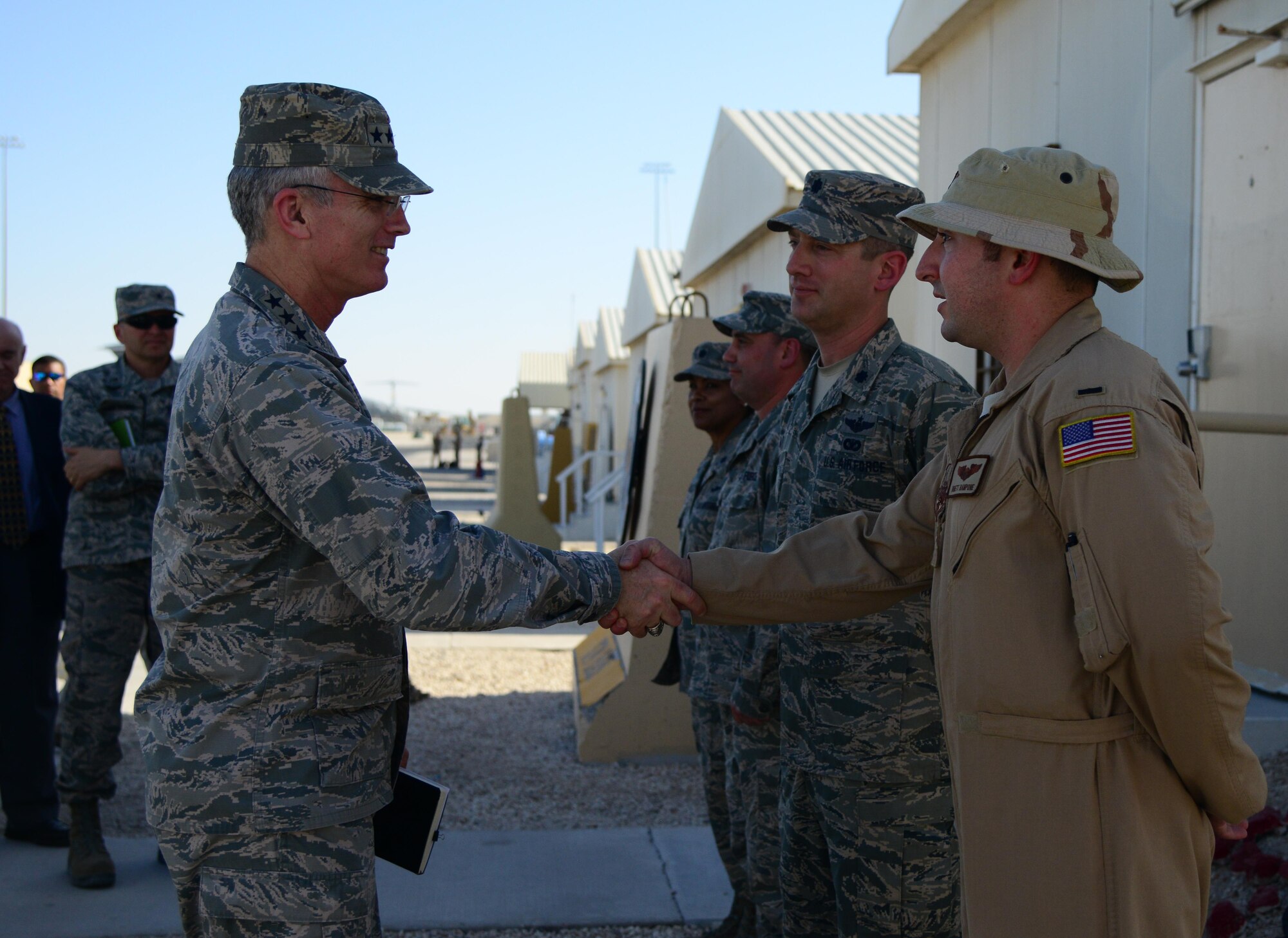 U.S. Air Force Gen. Paul Selva, left, commander of U.S. Transportation Command, shakes hands with 1st Lt. Brett Rampone, 746th Expeditionary Airlift Squadron, during his visit, Jan. 31, 2015, at Al Udeid Air Base, Qatar. The 746th EAS, equipped with the C-17 Globemaster III, provides airlift, airdrop and aeromedical evacuation capabilities. USTRANSCOM is the single manager of global air, land and sea transportation for the Department of Defense. (U.S. Air Force photo by Senior Airman Kia Atkins)