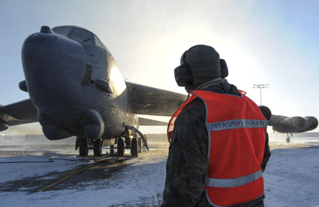 Airman 1st Class Yousef Sakhnini observes the engines of a B-52H Stratofortress before takeoff Feb. 4, 2015, on Minot Air Force Base, N.D. Sakhnini is a 5th Aircraft Maintenance Squadron crew chief.  His job requires him to be in constant communication with aircrew to ensure any discrepancies are identified and fixed before flight. (U.S. Air Force photo/Senior Airman Stephanie Morris)