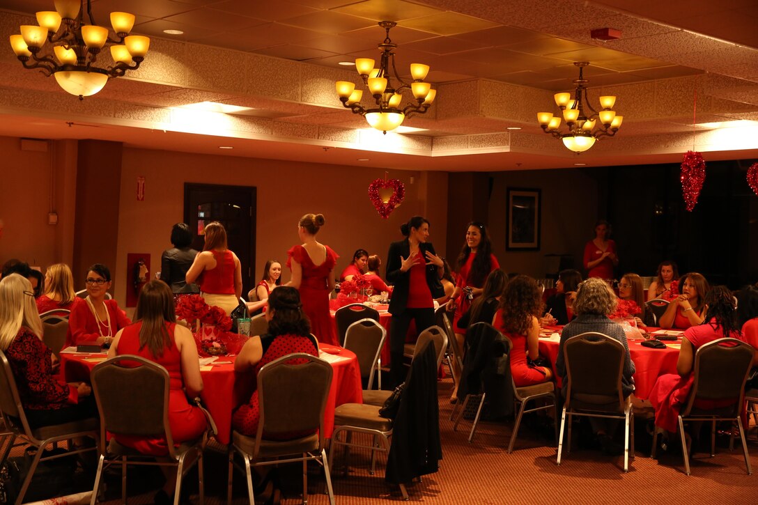 Combat Center patrons enjoy time together during The Heart Truth Red Dress Gala and Fashion Show held at the Officer’s Club, Feb. 5, 2015. Lifestyle Insights, Networking, Knowledge, and Skills program teamed up with the Officers Spouse Club in an effort to raise awareness about heart disease, which is the number one killer of women. (Official Marine Corps photo by Lance Cpl. Olivia Day/Released)