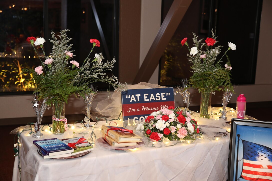 Healthy cookbooks and a sign are put on display during The Heart Truth Red Dress Gala and Fashion Show held at the Officers Club, Feb. 5, 2015. The night included guest speakers from the Naval Hospital, raffle giveaways for cookbooks and a fashion show of the spring line at the Marine Corps Exchange. (Official Marine Corps photo by Lance Cpl. Olivia Day/Released)