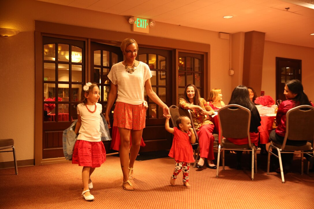 Tamara Belcher-Allen, spouse, native of Osceola, Mo., and her daughters Serena and Sophie walk the runway during The Heart Truth Red Dress Gala and Fashion Show held at the Officer’s Club, Feb. 5, 2015. (Official Marine Corps photo by Lance Cpl. Medina Ayala-Lo/Released)