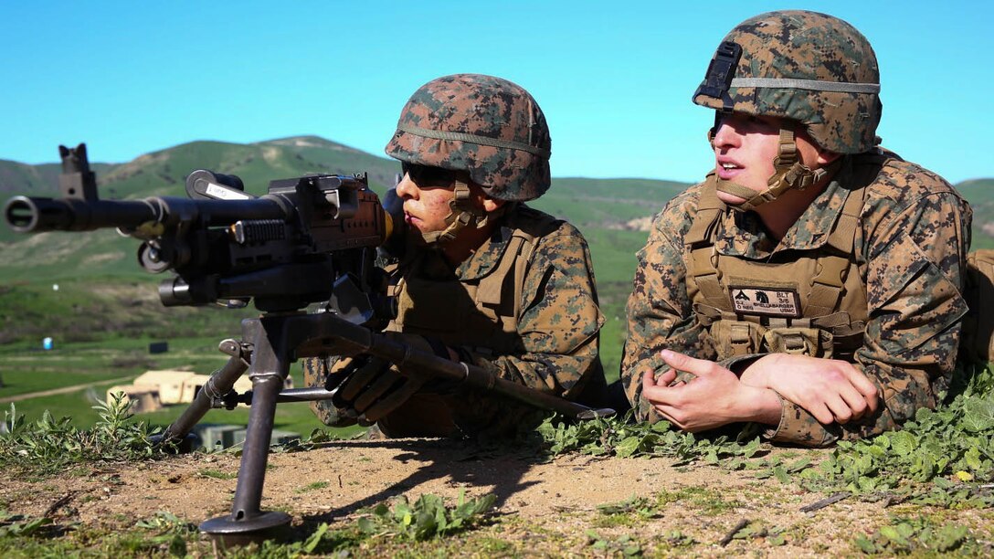 Lance Cpl. Connor J. Shellabarger, a machine gunner for Company K, 3rd Battalion, 5th Marines, 1st Marine Division, listens in along with his junior Marine, on the corrections his instructor has for him during a machine gun course aboard Marine Corps Base Camp Pendleton, Calif., Feb. 4, 2015. Shellabarger is bonding with his junior Marine to create the camaraderie Marines are known for.