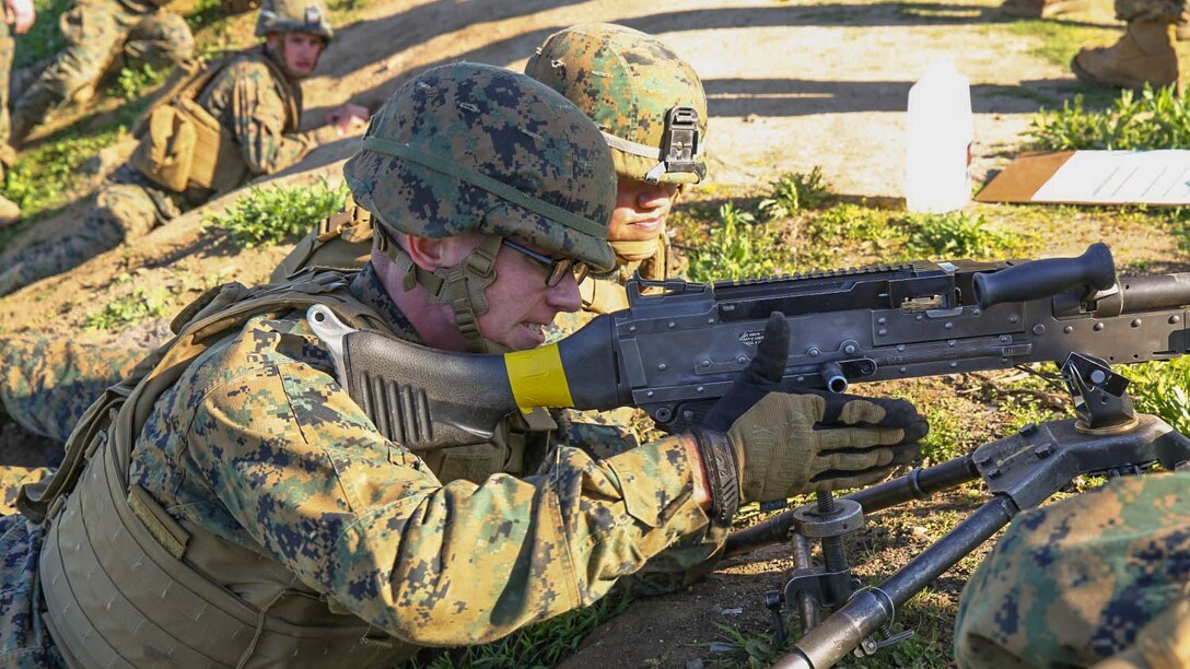Private First Class Benjamin P. Weathers, a machine gunner for Company K, 3rd Battalion, 5th Marines, 1st Marine Division, and Cpl. Meng Thao, a squad leader for Kilo Company, 3/5, assemble their M240B machine gun during a machine gun course aboard Marine Corps Base Camp Pendleton, Calif., Feb. 4, 2015. Thao demonstrated proper setup procedures to Weathers, testing Weathers’ knowledge of the weapon system after.