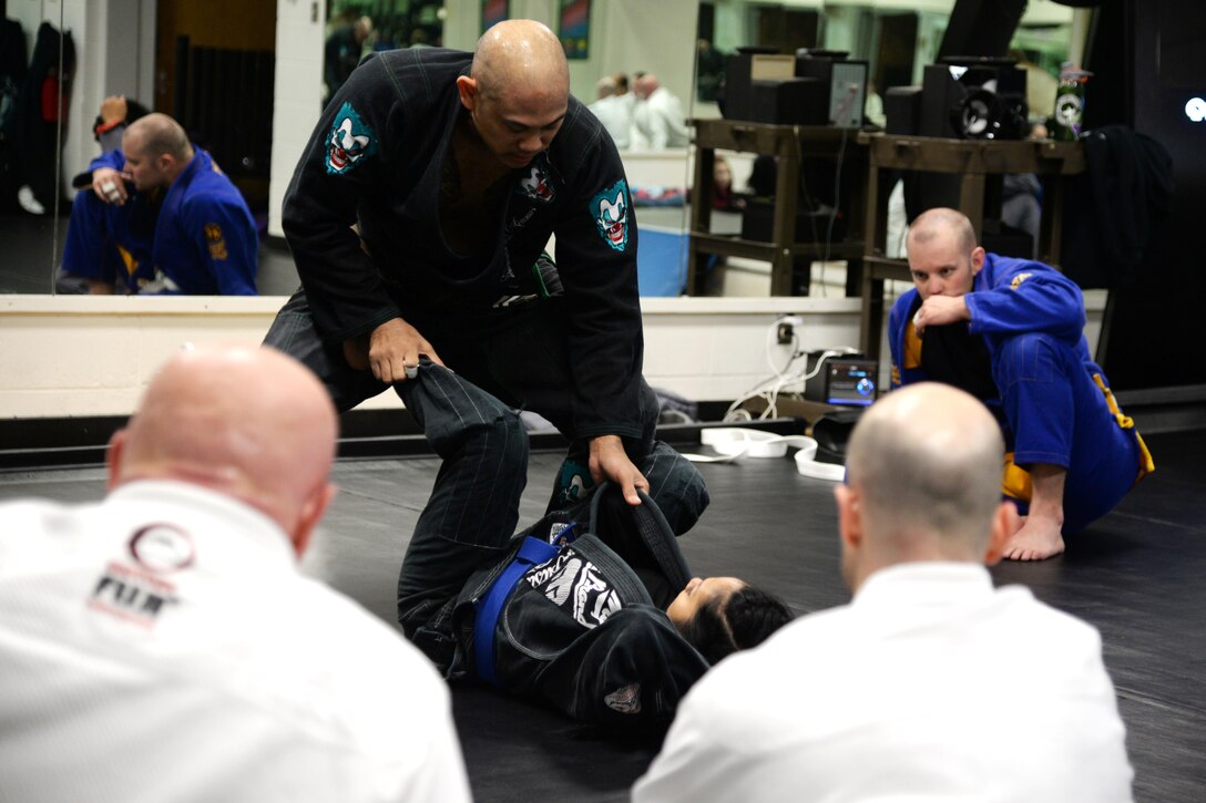 Senior Master Sgt. Jerome Capalad, 14th Civil Engineer Squadron Superintendent Fire Emergency Services, demonstrates to the class their next move during a Brazilian Jiu Jitsu class Feb. 9 at Columbus Air Force Base, Mississippi. Classes are offered every Monday, Wednesday and Friday at the Fitness Center. It is a free class, however purchase of a BJJ Kimono is necessary to participate. (U.S. Air Force Photo by Senior Airman Stephanie Englar)