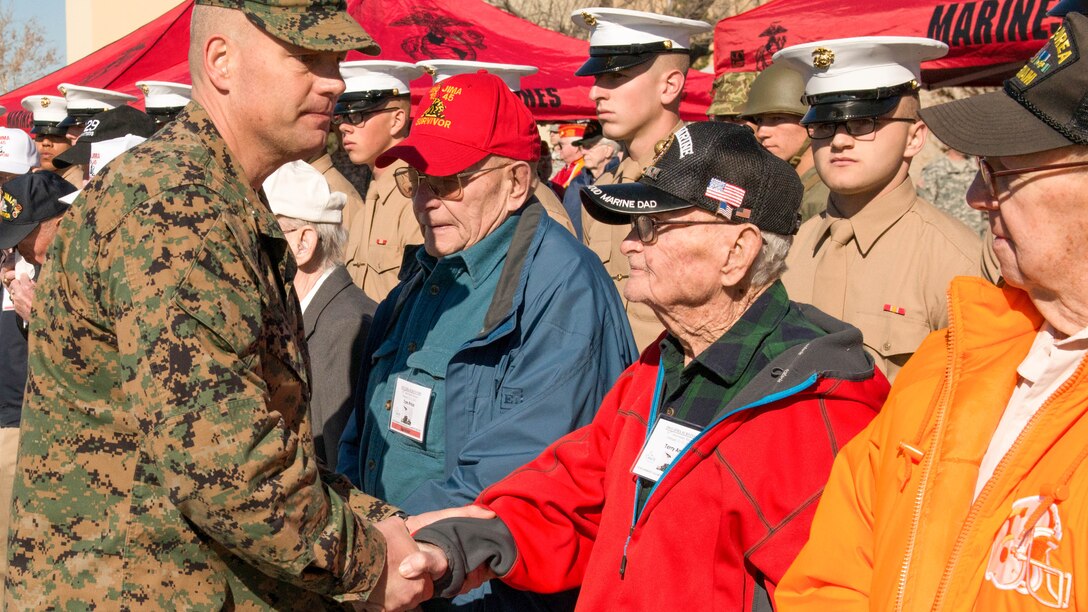 Col. Wayne Harrison, commanding officer of the Marine Artillery Detachment at Fort Sill, Oklahoma, shakes the hands of Iwo Jima veterans at the conclusion of a ceremony held to honor them and their service. The Marine Artillery Detachment performed a ceremony, provided a barbecue lunch and socialized with the Marines.