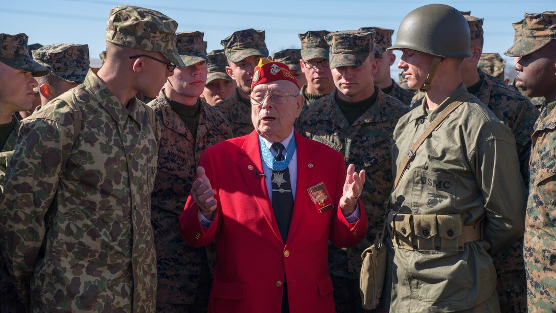 Marines from the Marine Artillery Detachment at Fort Sill, Oklahoma gather around Marine veteran and Medal of Honor recipient Hershel "Woody" Williams after a ceremony held to honor Iwo Jima veterans and their service. Williams is the last surviving veteran who was awarded the Medal of Honor for his actions during the battle for Iwo Jima.