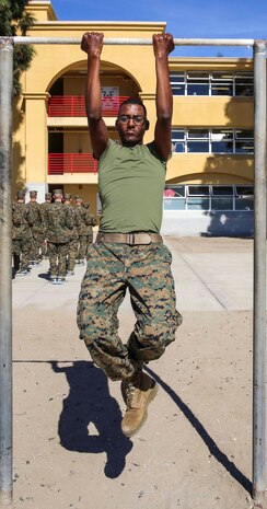 Private Yasbad G. Ukbamichael, Platoon 1027, Bravo Company, 1st Recruit Training Battalion, performs pull-ups during physical fitness training in recruit training at Marine Corps Recruit Depot San Diego, Feb. 11. Now that Ukbamichael has become a Marine, he will take a well-earned 10 days of leave before furthering his training at School of Infantry on Marine Corps Base Camp Pendleton for combat training and then on to learn his military occupational specialty as an amphibious assault crew member.