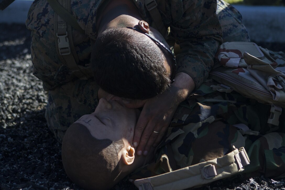 A Marine with 1st Reconnaissance Battalion demonstrates tactical combat casualty care on a training dummy, aboard Marine Corps Base Camp Pendleton, Calif., Feb. 10, 2015, during Exercise Iron Fist. Exercise Iron Fist is an annual bilateral training exercise between U.S. and Japanese military forces that builds their combined ability to conduct amphibious and land-based contingency operations. (Photo by Lcpl. Danielle Rodrigues/Released)