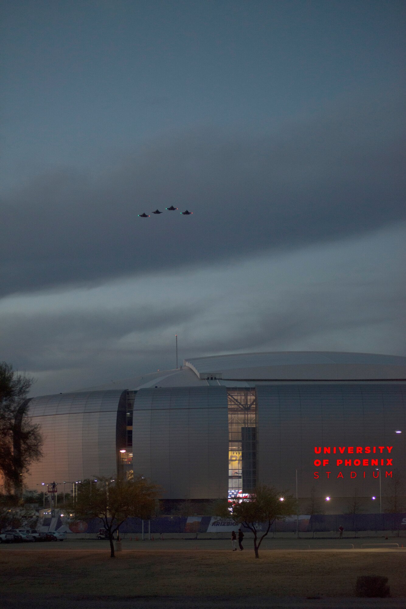 A four-ship formation of F-35 Lightning IIs perform the first-ever F-35 flyover Jan. 24 over University of Phoenix Stadium during the opening ceremonies of the 2015 Pro Bowl. (U.S. Air Force photo by Timothy Boyer)