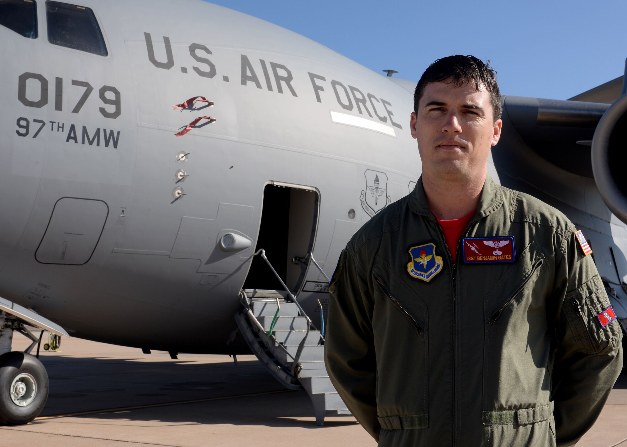 U.S. Air Force Tech. Sgt. Benjamin Gates, 58th Airlift Squadron flight chief of the operations flight, stands in front of a U.S. Air Force C-17 Globemaster III cargo aircraft on the flightline, Feb. 6, 2015. Gates has been awarded the Air Education and Training Command Vanguard Award for his heroic actions of aiding two drowning victims, ultimately saving one of their lives. (U.S. Air Force photo by Senior Airman Franklin R. Ramos/Released)