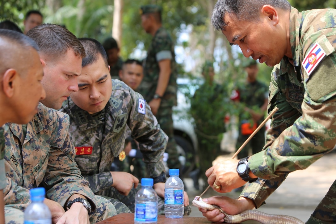 A Thai military instructor, known as “The Snake Man,” shows the  the size of a cobra’s fangs during a jungle survival training course Feb. 12, 2015 at Camp Lotawin, Kingdom of Thailand. U.S., Thai and Korean Marines participated in the course as part of training for exercise Cobra Gold 2015. (U.S. Marine Corps photo by Cpl. Joshua Murray)