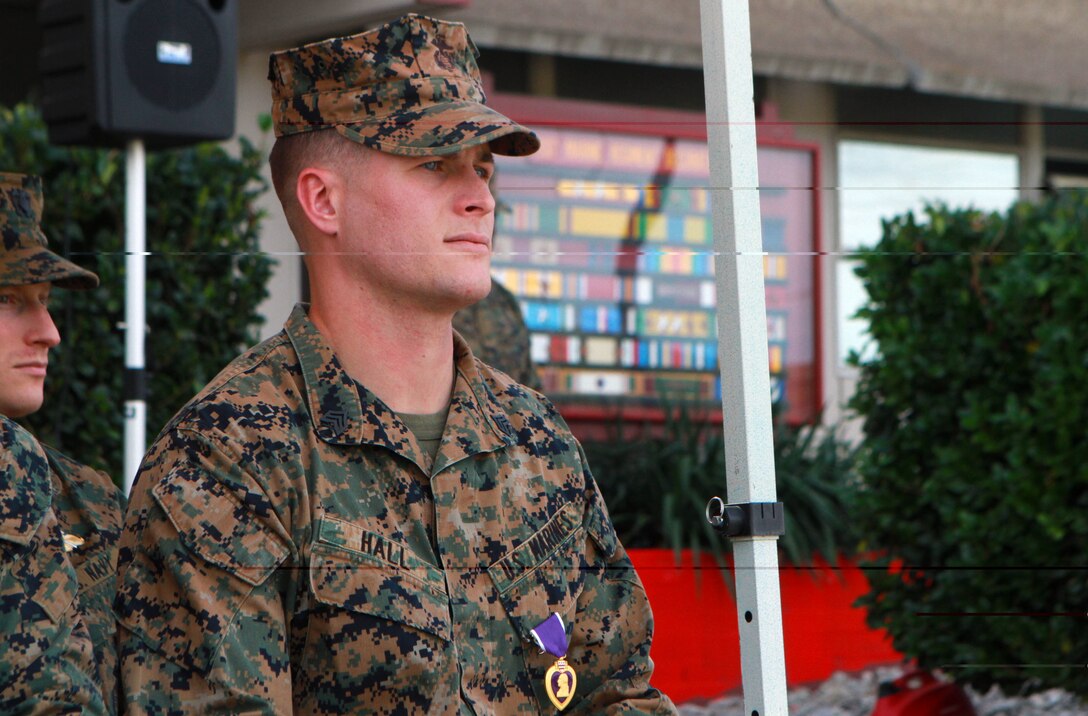 Sergeant Michael V. Hall II, a field radio operator with 1st Marine Regiment, 1st Marine Division, I Marine Expeditionary Force, listens to remarks from his commanding officer during his Purple Heart ceremony at Marine Corps Base Camp Pendleton, Calif., Feb. 11. Hall sustained wounds in Afghanistan while serving with Georgia Liaison Team 10 in November 2013.