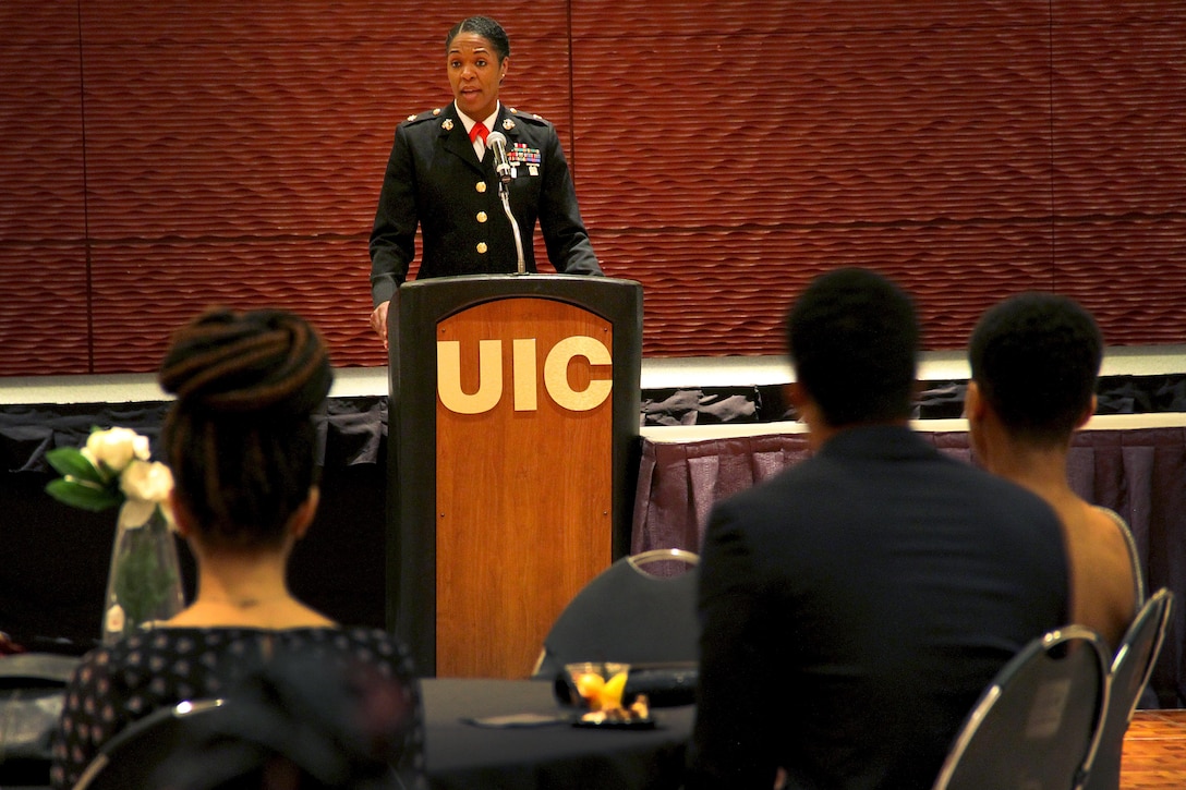 Maj. Shanelle Porter gives a speech during the Black Student Union Heritage Ball at the University of Illinois Chicago, Feb. 12. Porter is the commanding officer of Recruiting Station Chicago. She was chosen to be the guest of honor because of her illustrious past, and her promising future. During her speech, she advocated doing away with being “the first black person” to do something, because it’ll soon all be done. “I believe that if we all are willing to scale a jungle gym and not a ladder, have the will, the audacity and the courage to lead, and believe that when you arrive, you are supposed to be there, we will be great leaders and we will be excellent,” said Porter, who is the first black woman in Marine Corps history to command a recruiting station. “This is how we will move closer to there being no more firsts to achieve.”