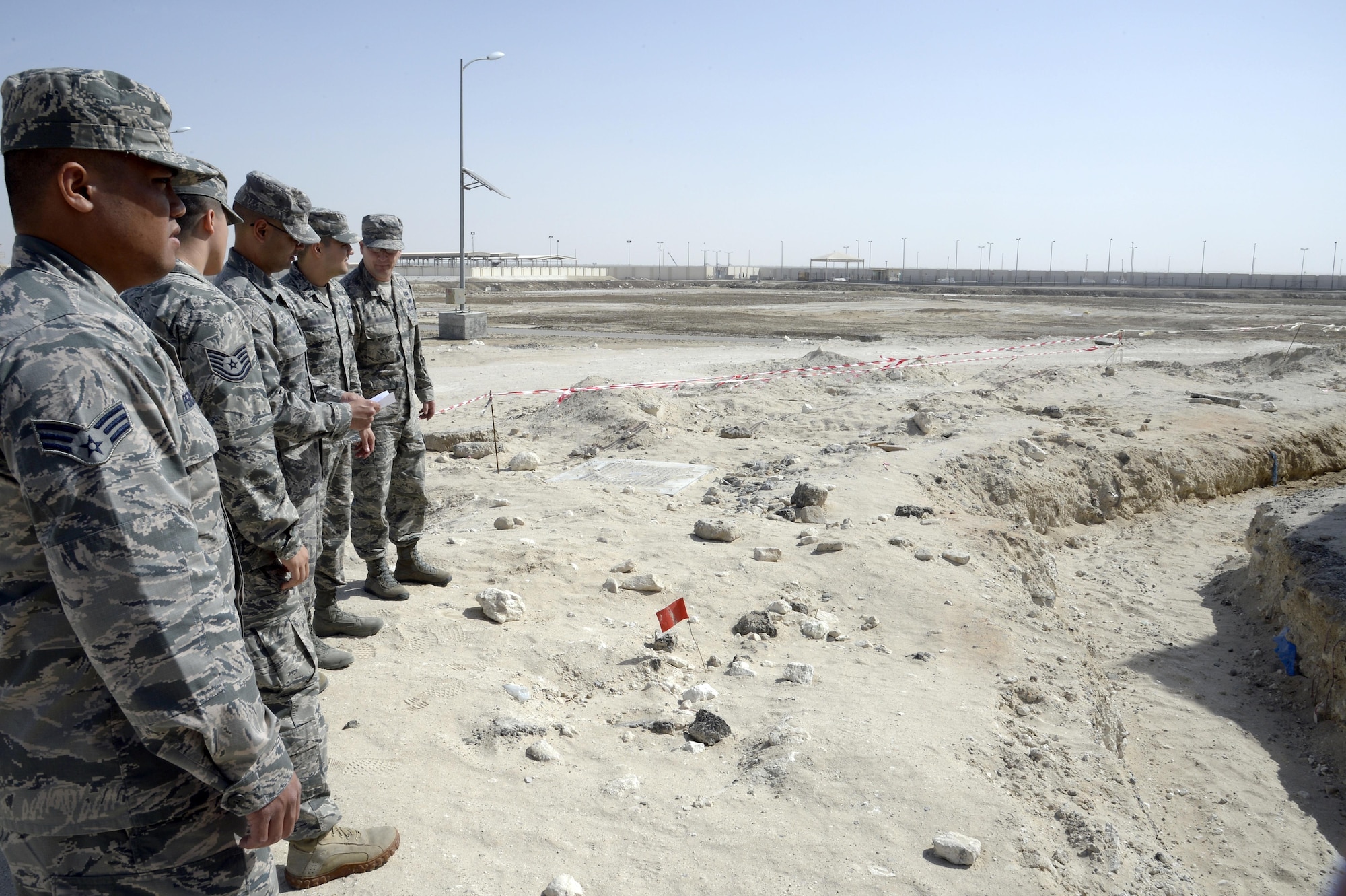 Airmen with the Expeditionary Contracting Squadron inspect a construction site at an undisclosed location in Southwest Asia Feb. 11, 2015. Contracting Airmen will usually inspect a work site at least monthly to ensure the work is progressing as agreed upon within the contract. (U.S. Air Force photo/Tech. Sgt. Marie Brown)