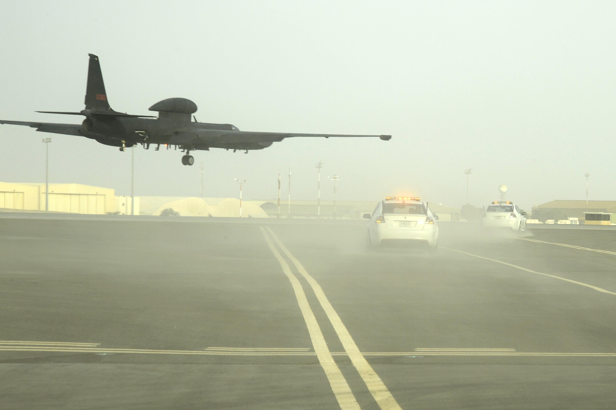 Chase cars prepare to catch a U-2 Dragon Lady as she comes in for a landing at an undisclosed location in Southwest Asia Feb. 9, 2015. The U-2 Dragon Lady provides high-altitude, all-weather surveillance and reconnaissance, day or night, in direct support of U.S. and allied forces. (U.S. Air Force photo/Tech. Sgt. Marie Brown