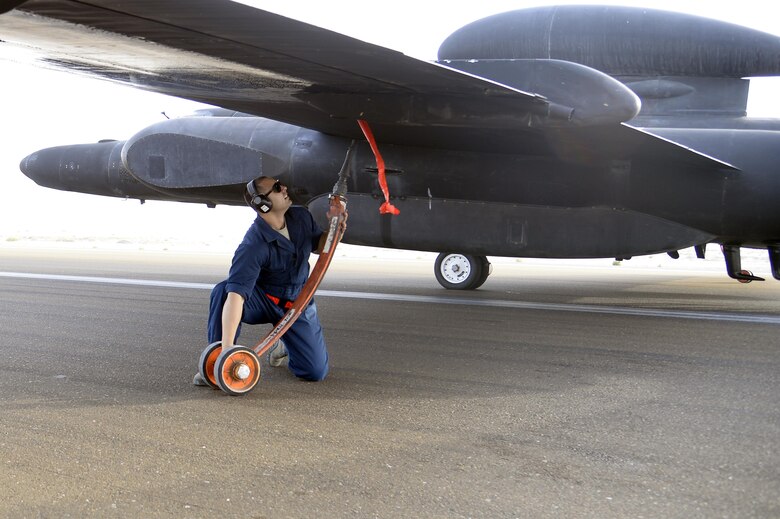 Staff Sgt. Ruben, Dragon Aircraft Maintenance Unit, installs a pogo wheel on a U-2 Dragon Lady at an undisclosed location in Southwest Asia Feb. 9, 2015. Dragon Aircraft Maintenance Unit provides strategic intelligence, surveillance, reconnaissance for all of the Central Commands area of responsibility. Ruben is currently deployed from Beale Air Force Base, Calif. (U.S. Air Force photo/Tech. Sgt. Marie Brown)