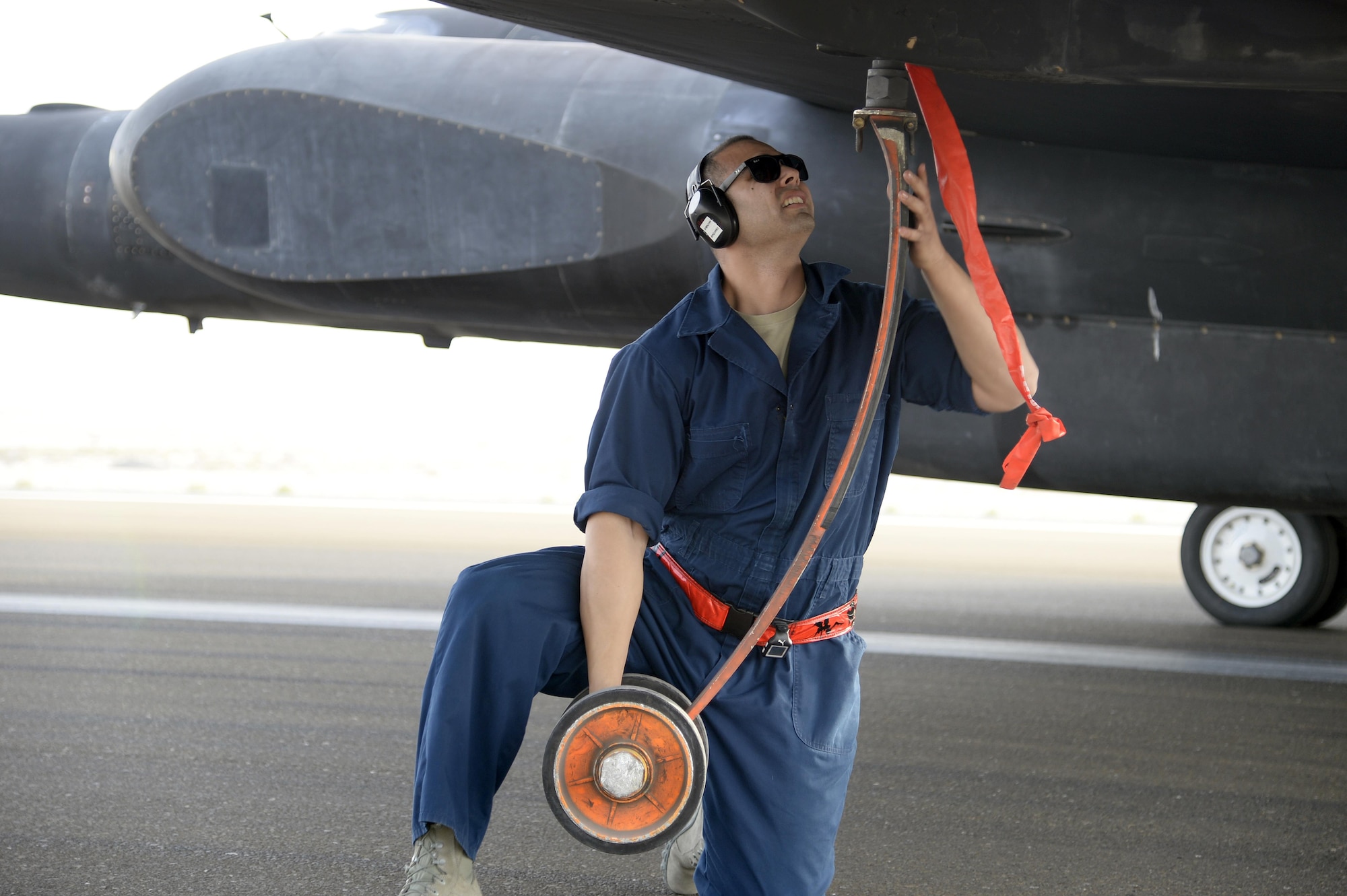 Staff Sgt. Ruben, Dragon Aircraft Maintenance Unit, installs a pogo wheel on a U-2 Dragon Lady at an undisclosed location in Southwest Asia Feb. 9, 2015. The U-2 uses pogo supports under each wing while it is on the ground to improve stability. Ruben is currently deployed from Beale Air Force Base, Calif. (U.S. Air Force photo/Tech. Sgt. Marie Brown)