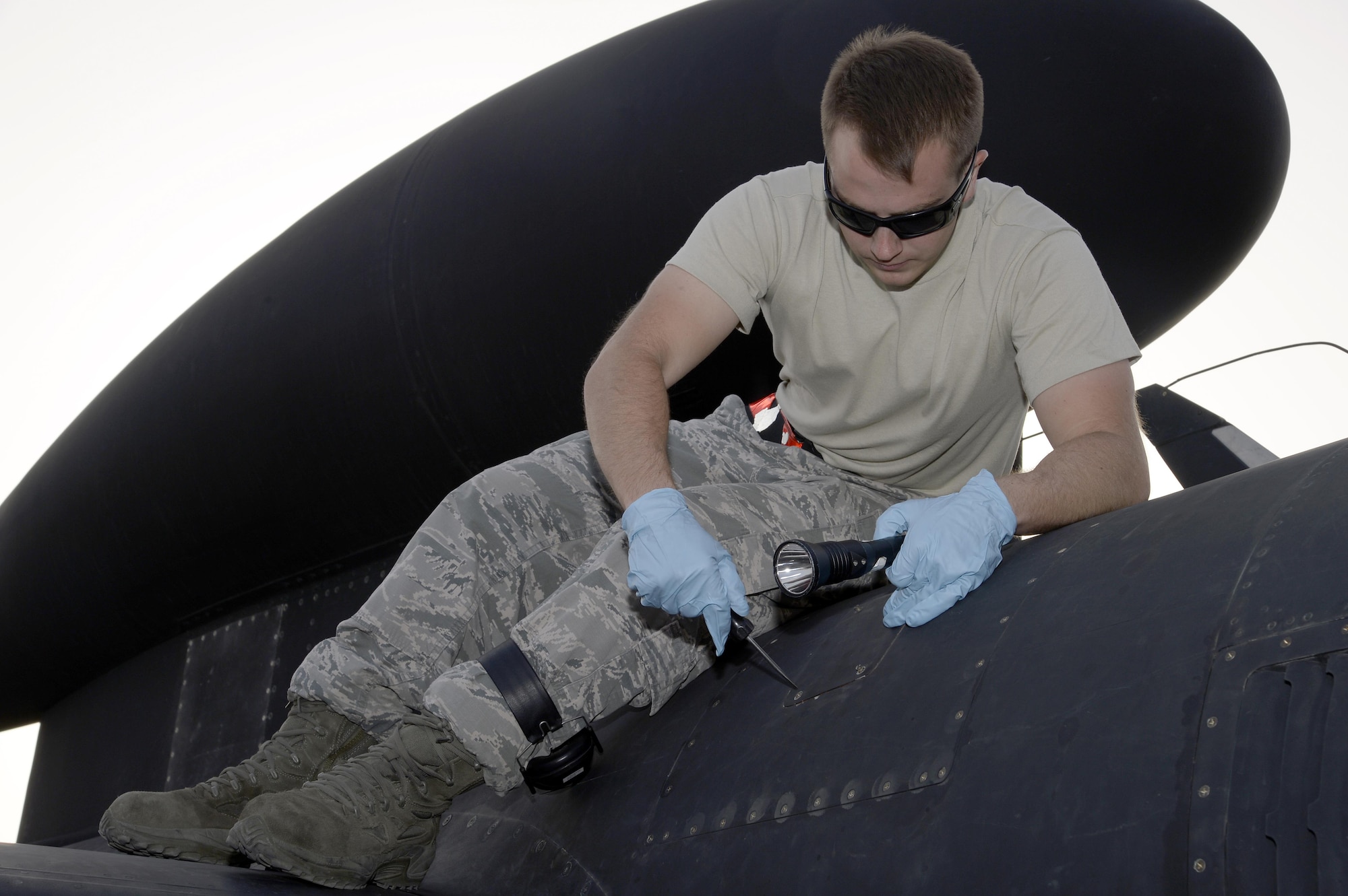 Senior Airman Jordan, Dragon Aircraft Maintenance Unit, prepares to open a panel on top of a U-2 Dragon Lady for a post-flight inspection at an undisclosed location in Southwest Asia Feb. 9, 2015. Because of the design of the U-2 Dragon Lady, the majority of which were built in the 1980s and a few in the 1960s, it takes many different specialties to keep this high-flying plane in the air. Jordan is currently deployed from Beale Air Force Base, Calif. (U.S. Air Force photo/Tech. Sgt. Marie Brown)