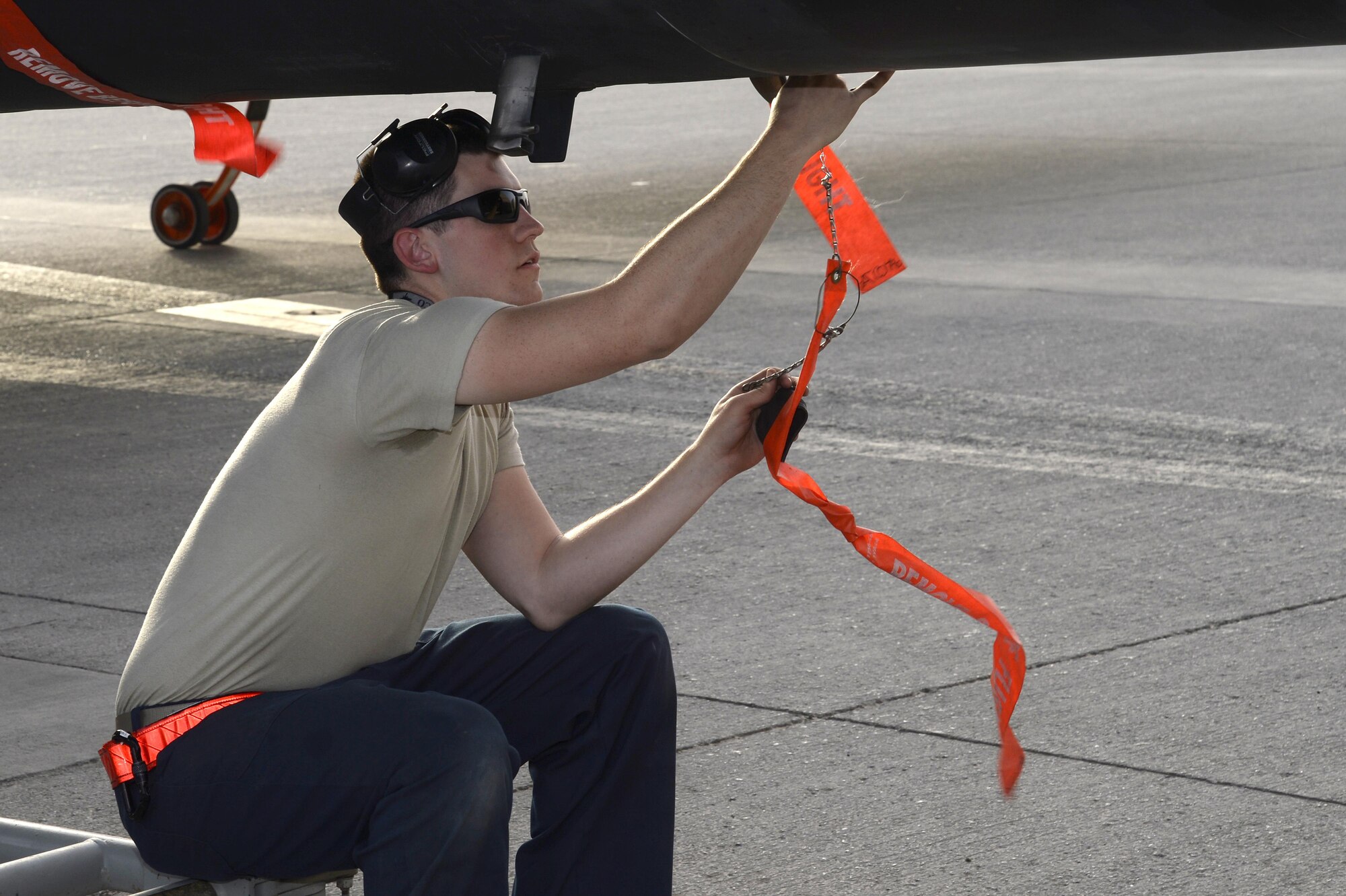 Airman 1st Class Christopher, Dragon Aircraft Maintenance Unit, installs a ‘remove before flight’ flag on a U-2 Dragon Lady in preparation for a post-flight inspection at an undisclosed location in Southwest Asia Feb. 9, 2015. Airmen with the Dragon AMU have been on a constant rotation here for about 11 years now and have played a pivotal role during many of the operations. Christopher is currently deployed from Beale Air Force Base, Calif. (U.S. Air Force photo/Tech. Sgt. Marie Brown)