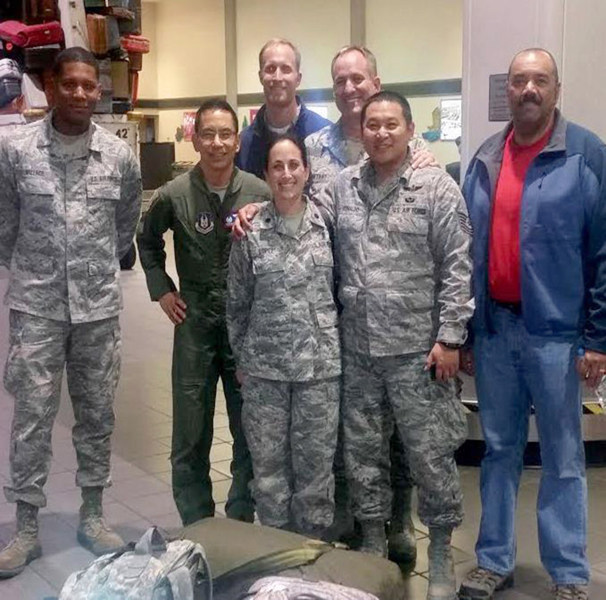 TRAVIS AIR FORCE BASE, Calif. -- Tech. Sgt. Aldwin Donaldo stops for a photo with his squadron mates at Sacramento International Airport. In front: Lt. Col. Kim Lopez, Donaldo, and Master Sgt. Steve Mitchell (civilian clothes). From the left, in the rear: Staff Sgt. Lauren Wallace, Lt. Col. Gerard Guevara, 349th AMOS commander, Maj. Matt Kartt, center rear, and Maj. Jerry Bryant. (Courtesy photo)
