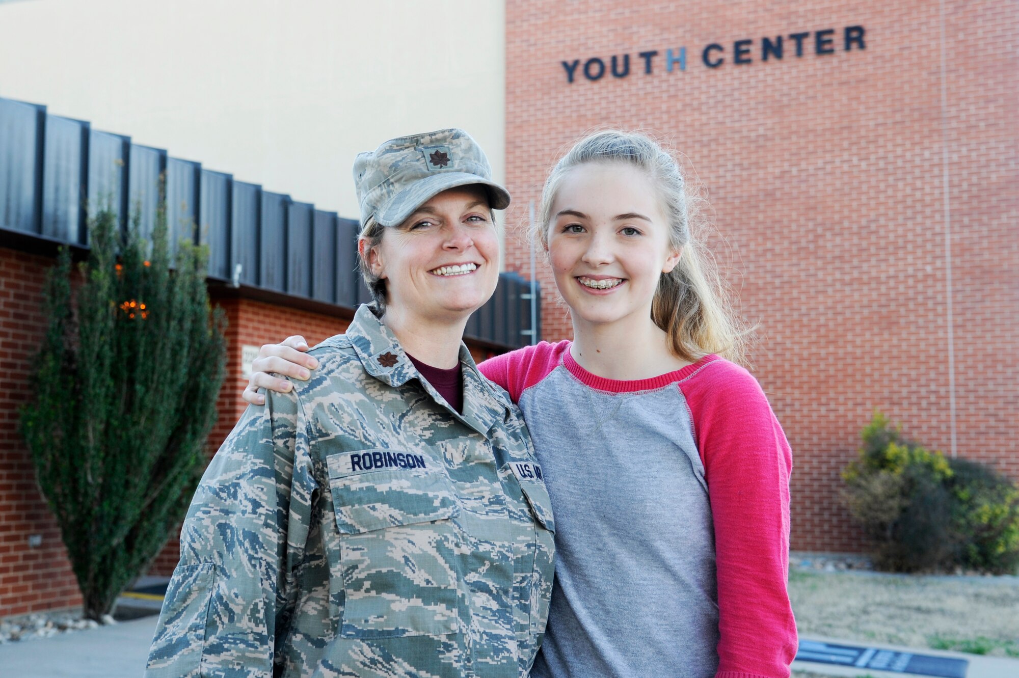 GOODFELLOW AIR FORCE BASE, Texas - Sophia A. Robinson, Robert E. Lee Middle School student and Goodfellow teen, and Maj. Nikki D. Robinson, 17th Medical Operations Squadron Clinic Medicine Flight Commander, pose for a photo at the Youth Center Feb. 6. Sophia is the Goodfellow Youth of the Year and will compete at the Texas level. (U.S. Air Force photo/ Tech. Sgt. Austin Knox)