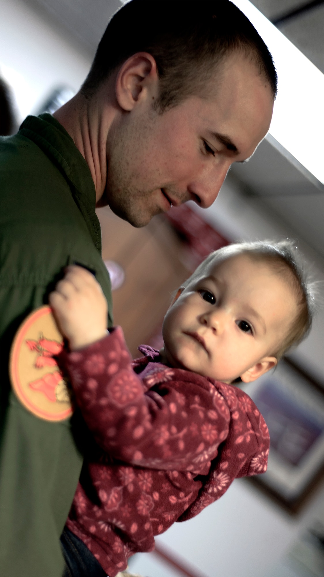 VANCE AIR FORCE BASE, Okla. -- 1st Lt. Bradley Elliott and his daughter Amelia Ann enjoy time with friends and family at a 33rd Flying Training Squadron family function, Feb. 6. “We’re our own little family and we take care of ourselves,” said Christy Starr, the wige of 33rd FTS commander Lt. Col. Michael Starr, of the Dragons’ tightly-knit community. “We try to have as many family and kid-inclusive events as we can so that no one moves to Vance and feels like they’re by themselves.” (U.S. Air Force photo / David Poe) 