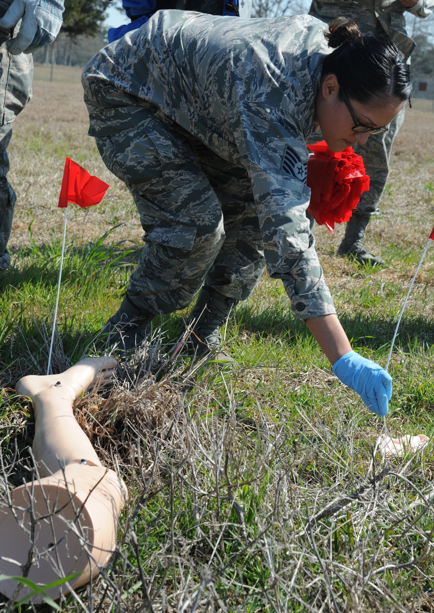 Tech. Sgt. Angelica Santana, 81st Aerospace Medicine Squadron flight medicine non-commissioned officer in charge, flags a “body part” in the search and recovery efforts during a major accident response exercise Feb. 12, 2015, on the flight line, Keesler Air Force Base, Miss.  The MARE simulated a C-130J Hercules aircraft crash on base. The exercise was held to test the readiness of Keesler personnel during a major accident.  (U.S. Air Force photo by Kemberly Groue)