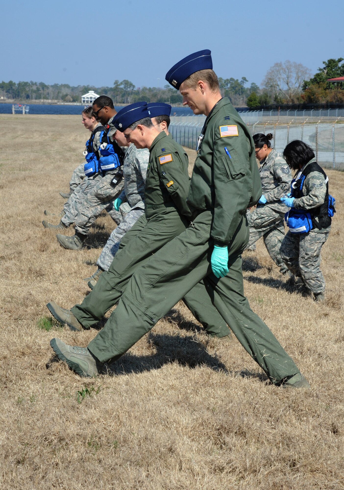 Capt. Chase Rogers, (front), and Lt. Col. Michael Coghlan, 81st Aerospace Medicine Squadron flight surgeons, assist the search and recovery team during a major accident response exercise Feb. 12, 2015, on the flight line, Keesler Air Force Base, Miss.  The MARE simulated a C-130J Hercules aircraft crash on base. The exercise was held to test the readiness of Keesler personnel during a major accident.  (U.S. Air Force photo by Kemberly Groue)