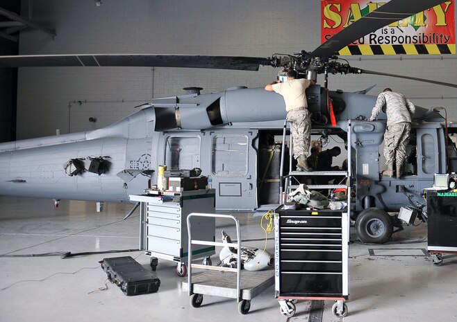Airmen from the 823rd Maintenance Squadron perform maintenance on an HH-60G Pave Hawk at Nellis Air Force Base, Nev., Jan. 12, 2015. The 823d MXS’ mission is to deliver safe and reliable HH-60s along with effective Airmen to conduct personnel recovery missions that include combat search and rescue as well as humanitarian relief operations in any environment worldwide. (U.S. Air Force photo by Airman 1st Class Rachel Loftis)