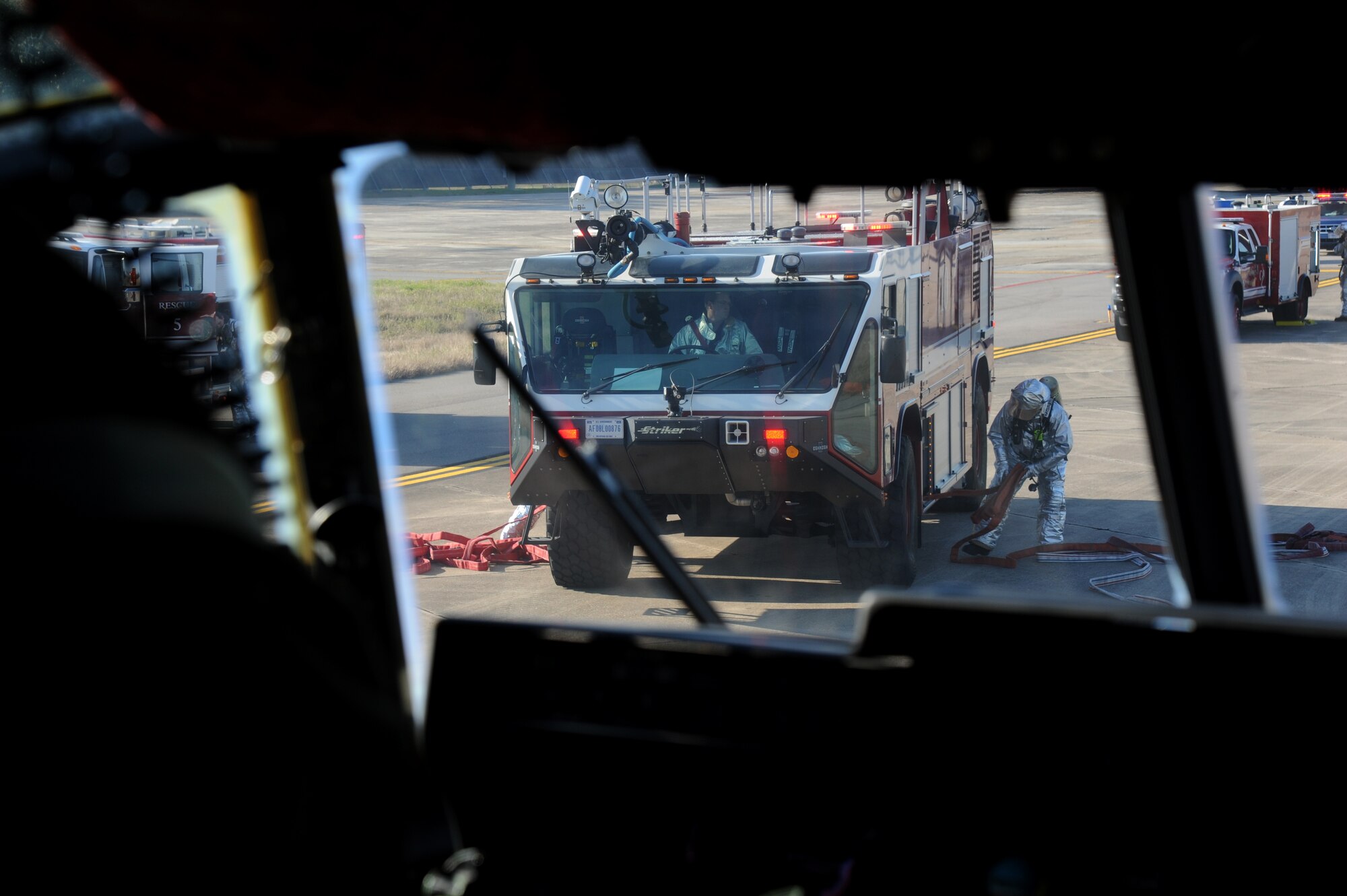 Keesler firefighters respond during a major accident response exercise Feb. 12, 2015, on the flight line, Keesler Air Force Base, Miss.  The MARE simulated a C-130J Hercules aircraft crash on base. Exercises are held periodically to prepare for real world emergencies.  (U.S. Air Force photo by Kemberly Groue)