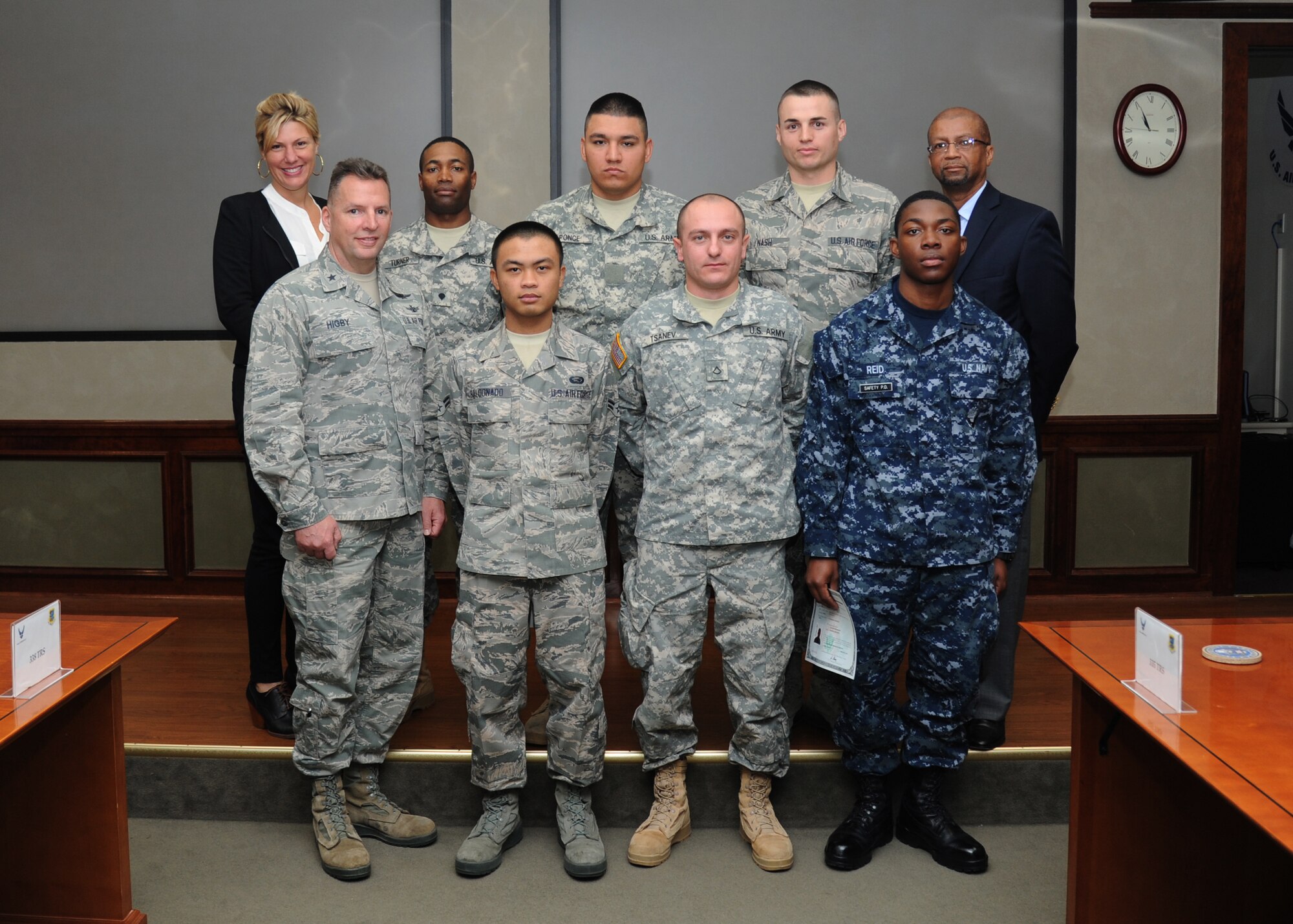 Six military members from different branches of service pose for a photo following a U.S. Naturalization Ceremony where they received their U.S. citizenship during a Feb. 11, 2015, at Stennis Hall, Keesler Air Force Base, Miss.  This is the first time Keesler has hosted a naturalization ceremony.  (U.S. Air Force photo by Kemberly Groue)