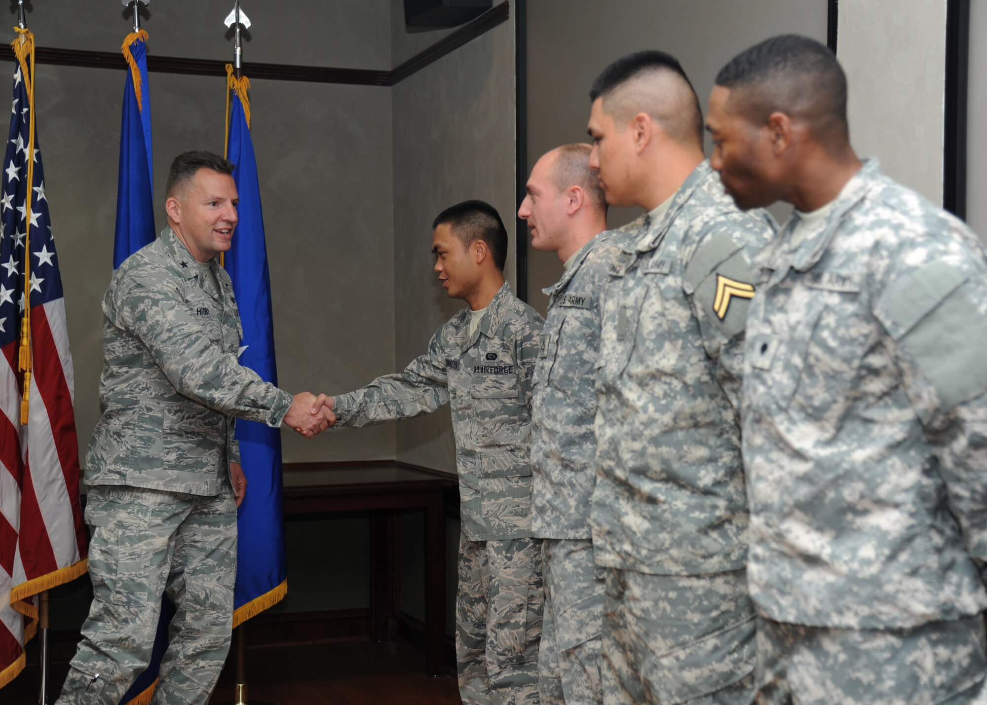 Brig. Gen. Patrick Higby, 81st Training Wing commander, congratulates Airman 1st Class Jmb Baldonado, 81st Force Support Squadron customer support technician, during a U.S. Naturalization Ceremony, Feb. 11, 2015, at Stennis Hall, Keesler Air Force Base, Miss.  This was the first time Keesler hosted a naturalization ceremony.   Six military members received their U.S. citizenship.  (U.S. Air Force photo by Kemberly Groue)
