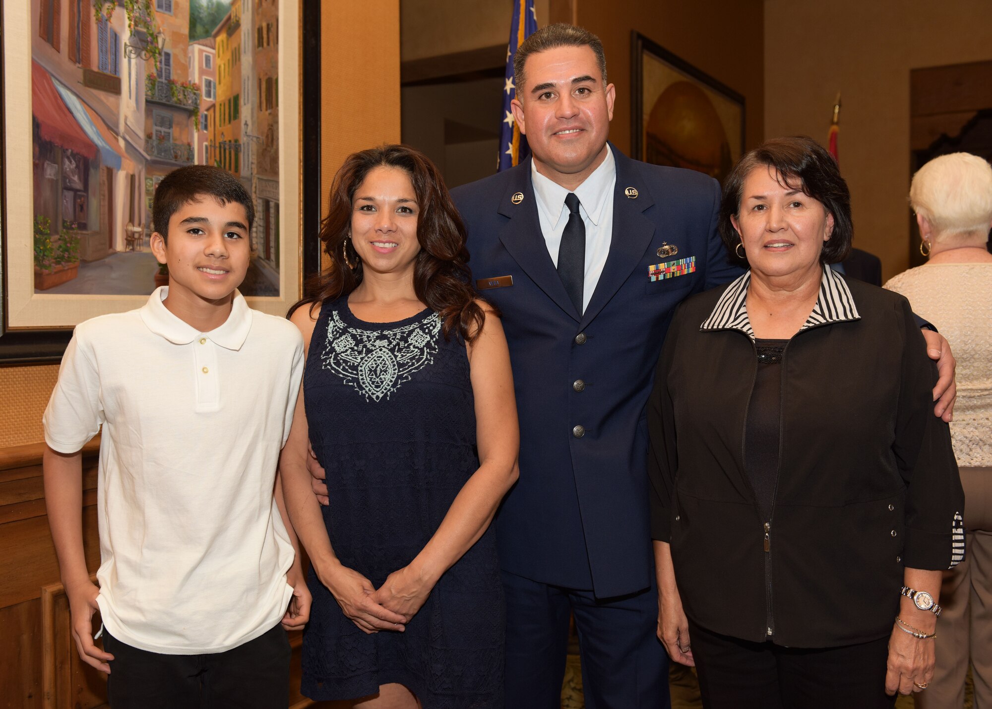 Tech. Sgt. Louis Vega Jr., poses with his family Feb 11 after receiving the Graydon Williams Award at the Pebble Creek Country Club, Goodyear, Ariz. From left to right: Vicente Vega, son; Christine Vega, wife and Kathleen Pantoja, mother. (U.S. Air Force photo by Staff Sgt. Lausanne Kinder)
