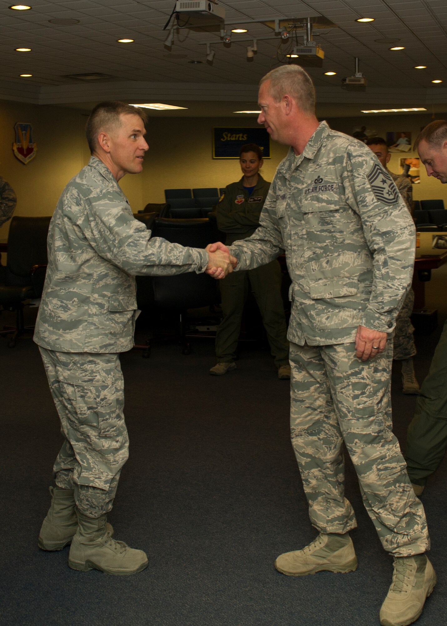 Colonel Robert Letourneau, 49th Material Maintenance Group commander welcomes Chief Master Sgt. Scott Loescher, Holloman’s newest command chief, at Holloman Air Force Base, N.M., Feb. 13. Loescher entered the U.S. Air Force in 1988 as a Tactical Air Command and Control Specialist, and has spent his career delivering close-air-support for ground troops all over the world. His tours have included Desert Shield, Desert Storm, Deny Flight, Iraqi Freedom, New Dawn, and Enduring Freedom. He enjoys spending his off time outdoors and being away from his desk. “I am humbled that Col. Kiebler has asked me to be the 49th Wing’s next command chief, and I am excited for the opportunity to help our Airmen grow into future leaders,” said Loescher. (U.S. Air Force photo by Senior Airman Leah Ferrante/released)