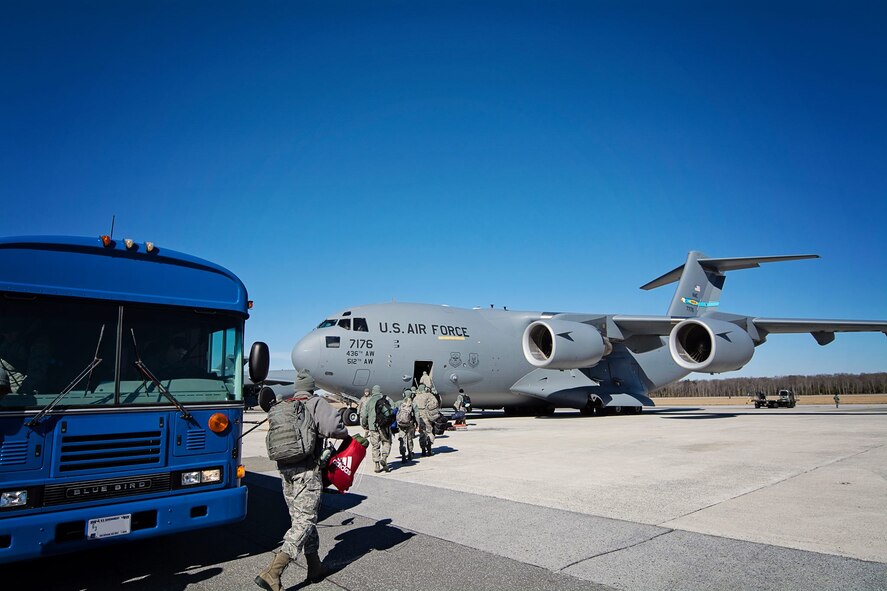 Nearly 20 512th Maintenance Group reservists board a C-17 Globemaster III on Dover Air Force Base, Del., Feb. 13, 2015. The team is headed to Germany, where they will train and assist in aircraft maintenance for two weeks in the European Command. (U.S. Air Force photo/Capt. Bernie Kale)