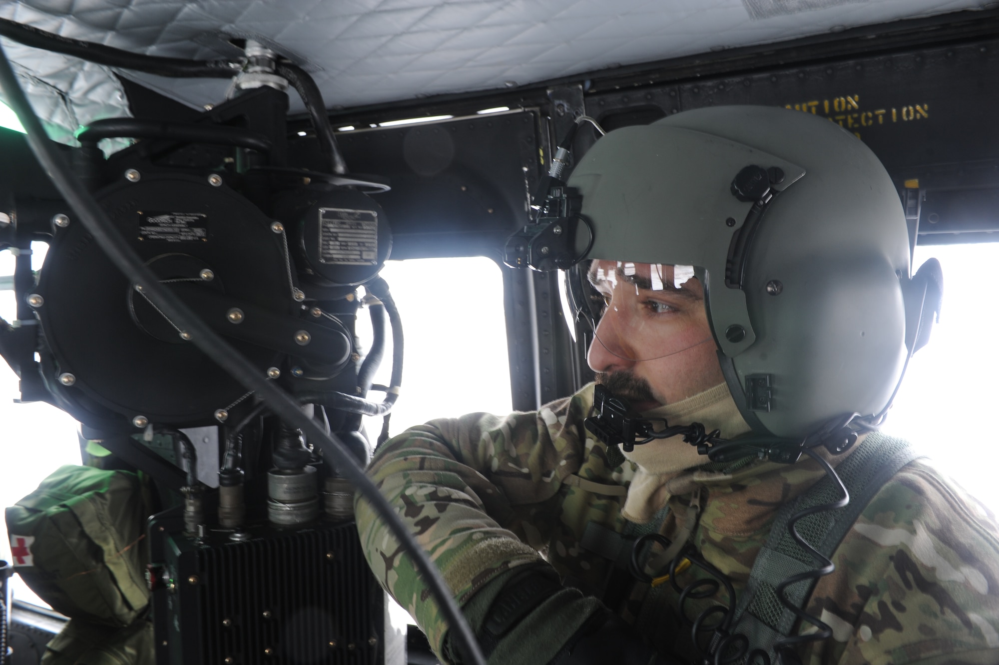 Tech. Sgt. Thomas Liscomb, 54th Helicopter Squadron flight engineer, checks his gear in a UH1-N helicopter near Minot Air Force Base, N.D., Feb. 11, 2015. Liscomb and a team of five other individuals dispatched to an area surrounding the base and practiced search and rescue operations. (U.S. Air Force photos/Senior Airman Stephanie Morris)