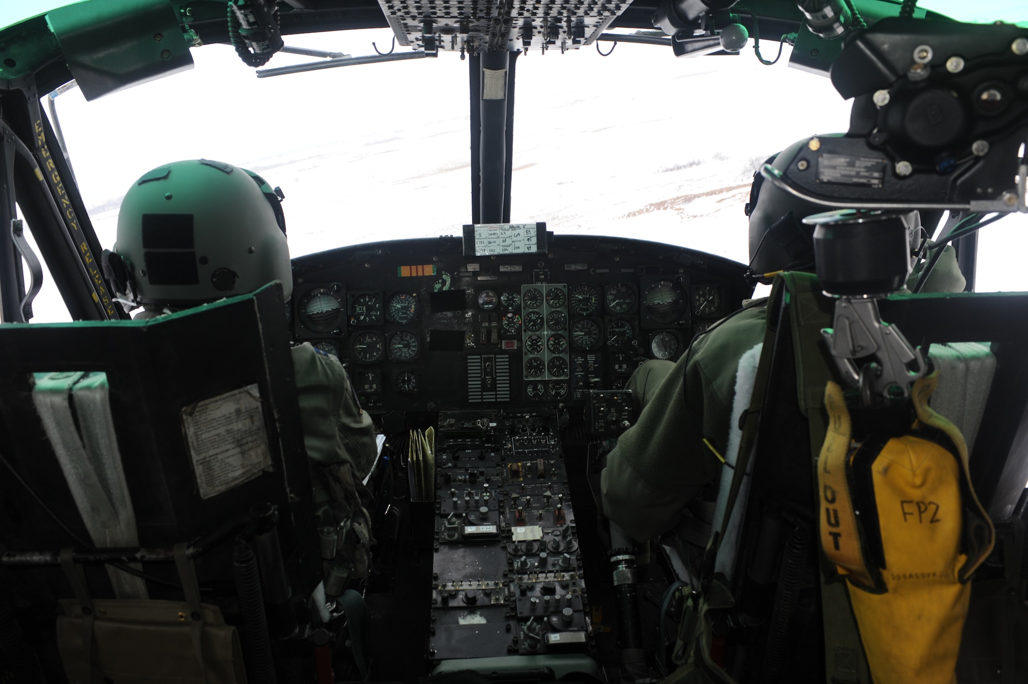 Capt. Jonathan Bonilla, 54th Helicopter Squadron aircraft commander, and 1st Lt. Kyle Nelson, 54th HS co-pilot, maneuver a UH1-N helicopter during a training mission near Minot Air Force Base, N.D., Feb. 11, 2015. During the training, the crew had to account for blowing snow and extreme low temperatures as they tested their search and rescue skills. (U.S. Air Force photos/Senior Airman Stephanie Morris)