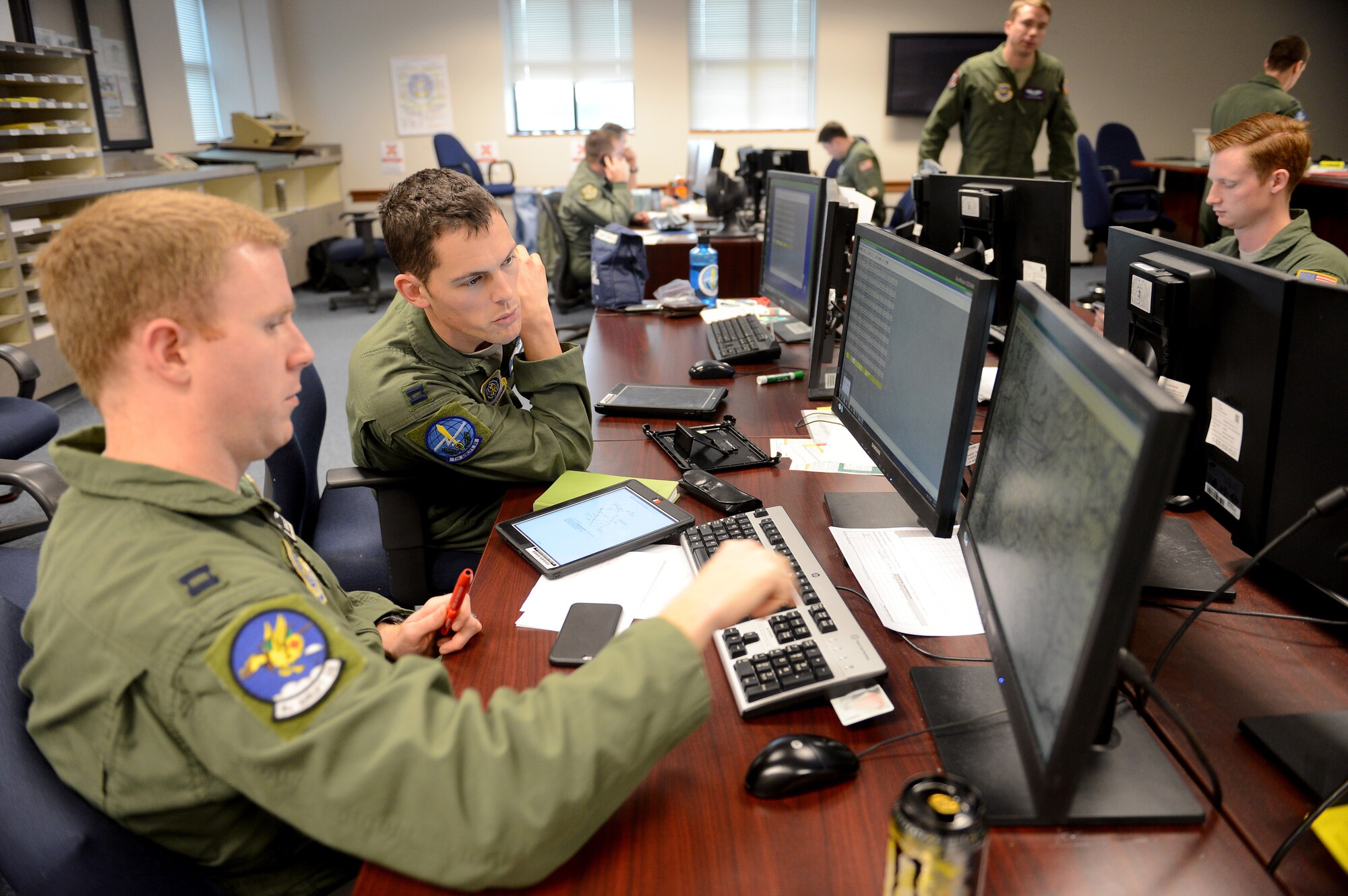 Capt. Matthew Hall (right), 7th Airlift Squadron chief of mission planning cell and Capt. Brad Fisher, 8th Airlift Squadron deputy chief of mission planning cell, review a mission plan on a computer Feb. 3, 2015, during Exercise SNAPSHOT at Joint Base Lewis-McChord, Wash. Inside the mission planning cell, exercise coordinators worked around McChord Field’s real-time operations while making the five-day long exercise a priority. (U.S. Air Force photo/Airman 1st Class Keoni Chavarria)