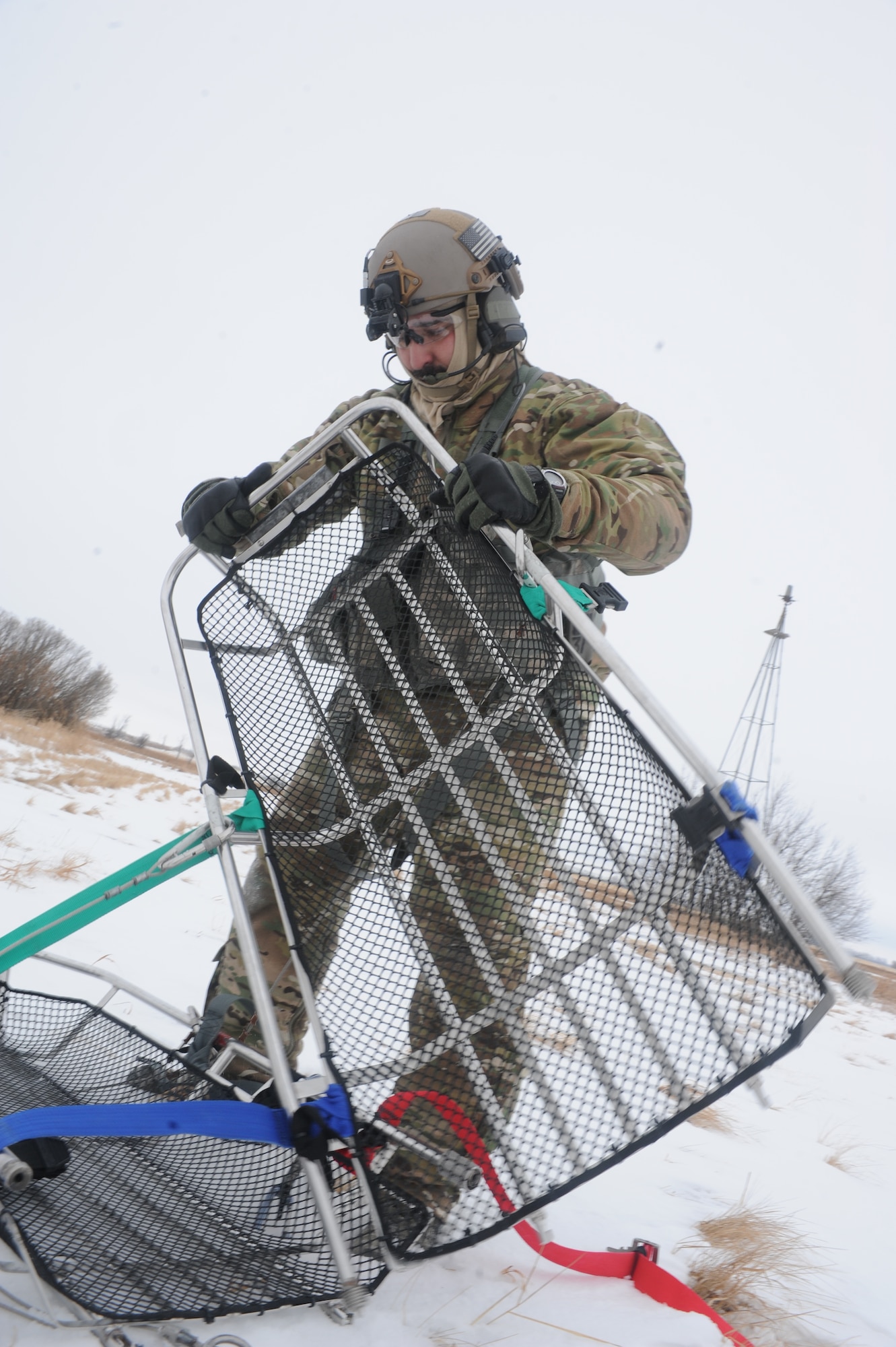 Tech. Sgt. Thomas Liscomb, 54th Helicopter Squadron flight engineer, assembles a litter near Minot Air Force Base, N.D., Feb. 11, 2015. The litter was used during training to test the crews search and rescue capabilities. (U.S. Air Force photos/Senior Airman Stephanie Morris)