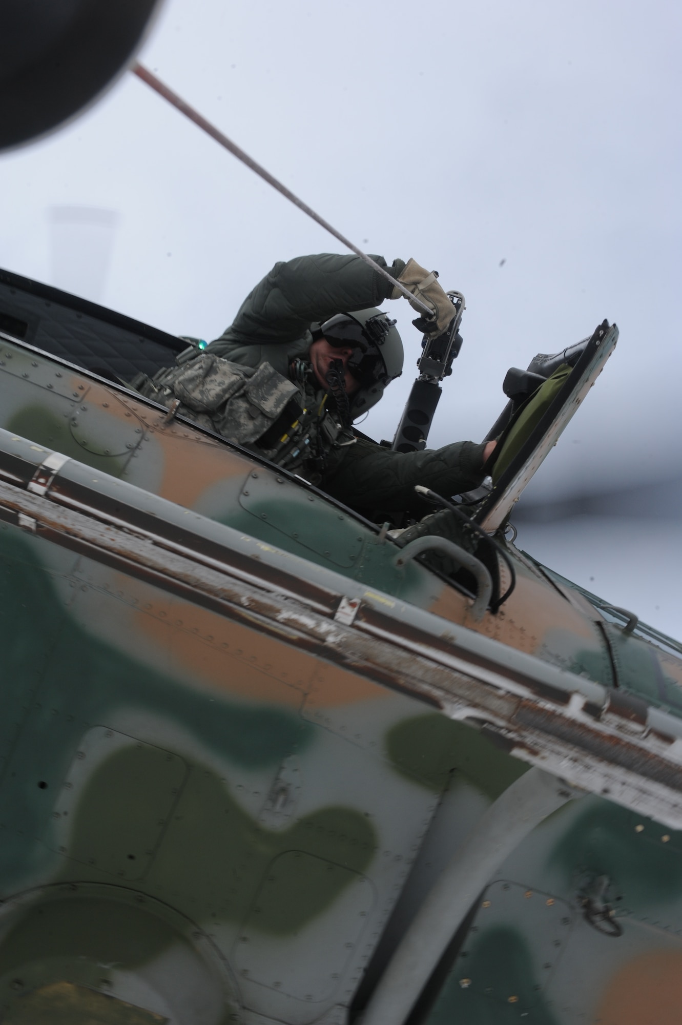 Master Sgt. Austin Atkinson, 54th Helicopter Squadron flight engineer, raises a force penetrator during a training mission near Minot Air Force Base, N.D., Feb. 11, 2015. The crew tested their accuracy with the hoist, performed a series of live extractions and practiced with an unmanned litter. (U.S. Air Force photos/Senior Airman Stephanie Morris)