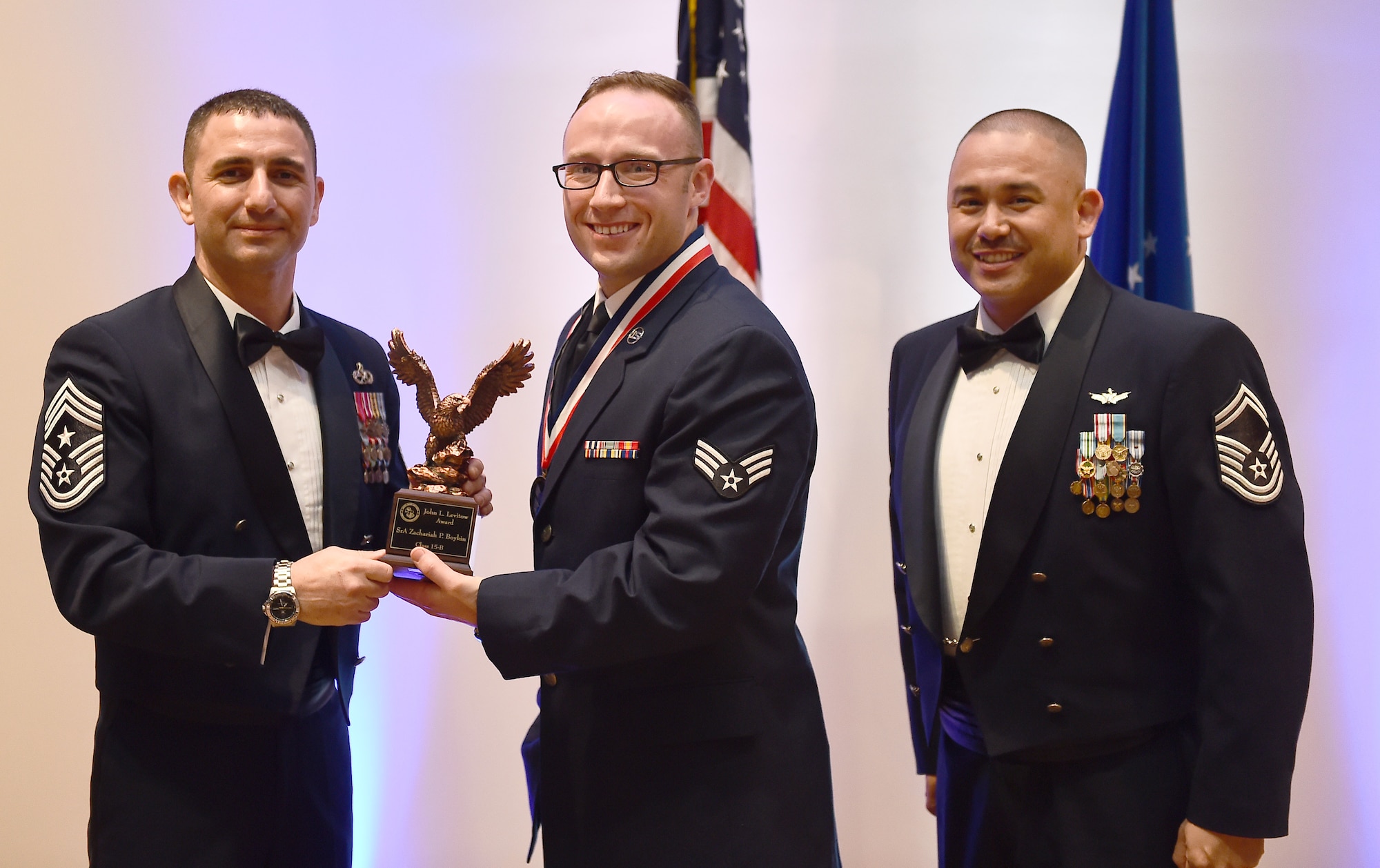 Senior Airman Zachariah P. Boykin, member of the 566th Intelligence Squadron, receives the John L. Levitow Award during the Buckley Airman Leadership School Class 15-B graduation Feb. 12, 2015, at the Leadership Development Center on Buckley Air Force Base, Colo. The Levitow award is given to the ALS graduate with the highest academic scores and leadership potential. (U.S. Air Force photo by Airman 1st Luke Nowakowski /Released)