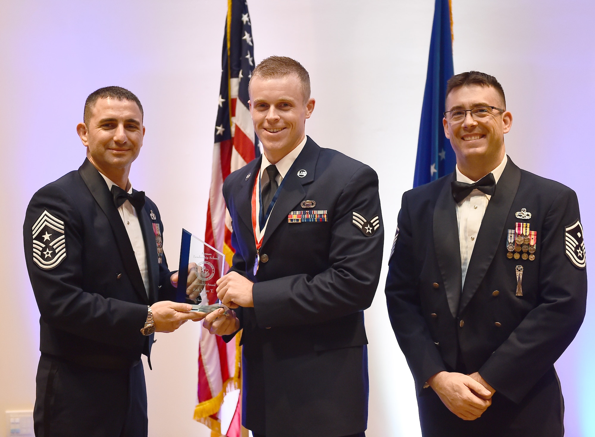 Senior Airman Marc T. Scott, member of the 566th Intelligence Squadron, receives the Leadership Award during the Buckley Airman Leadership School Class 15-B graduation Feb. 12, 2015, at the Leadership Development Center on Buckley Air Force Base, Colo. This award is presented to the graduate who displays the best overall characteristics of an effective leader. (U.S. Air Force photo by Airman 1st Class Luke Nowakowski/Released)
