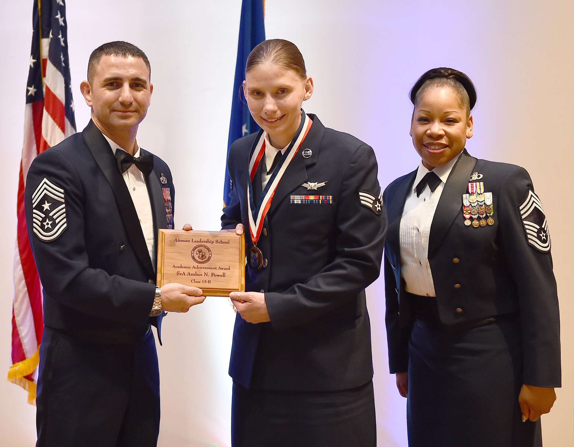 Senior Airman Amber N. Powell, member of the 460th Operations Support Squadron, receives the Academic Achievement Award during the Buckley Airman Leadership School Class 15-B graduation Feb. 12, 2015, at the Leadership Development Center on Buckley Air Force Base, Colo. This award is presented to the student with the highest overall average on all academic evaluations during ALS. (U.S. Air Force photo by Airman 1st Class Luke Nowakowski/Released)