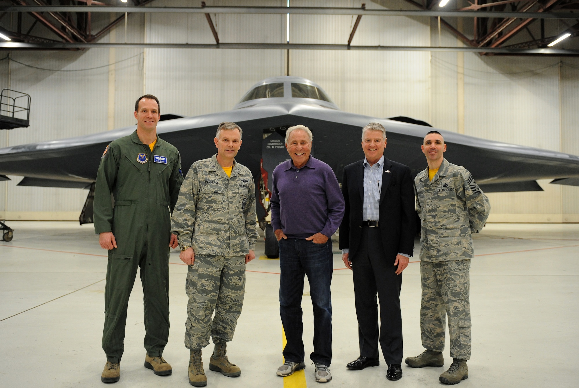 Lee Corso, ESPN college football analyst and retired Maj. Gen. Anthony Przybyslawski, former 509th Bomb Wing commander, poses with current 509th BW leadership in front of a B-2 Spirit at Whiteman Air Force Base, Mo., Feb. 6, 2015. Corso was the guest speaker during Whiteman’s 2014 Annual Awards Banquet. (U.S. Air Force photo by Airman 1st Class Joel Pfiester/Released)