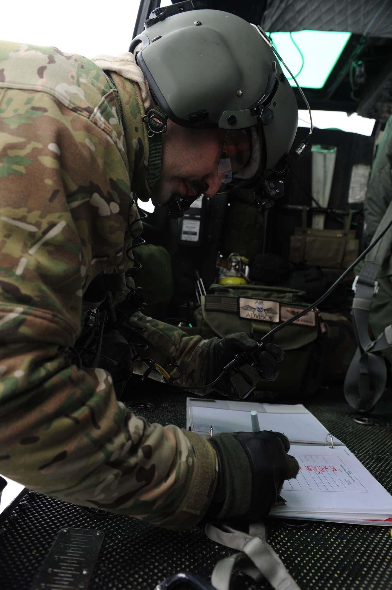 Tech. Sgt. Thomas Liscomb, 54th Helicopter Squadron flight engineer, reviews flight information for a UH1-N helicopter training mission on Minot Air Force Base, N.D., Feb. 11, 2015. The mission tested search and rescue capabilities in low-temperature conditions. (U.S. Air Force photos/Senior Airman Stephanie Morris)