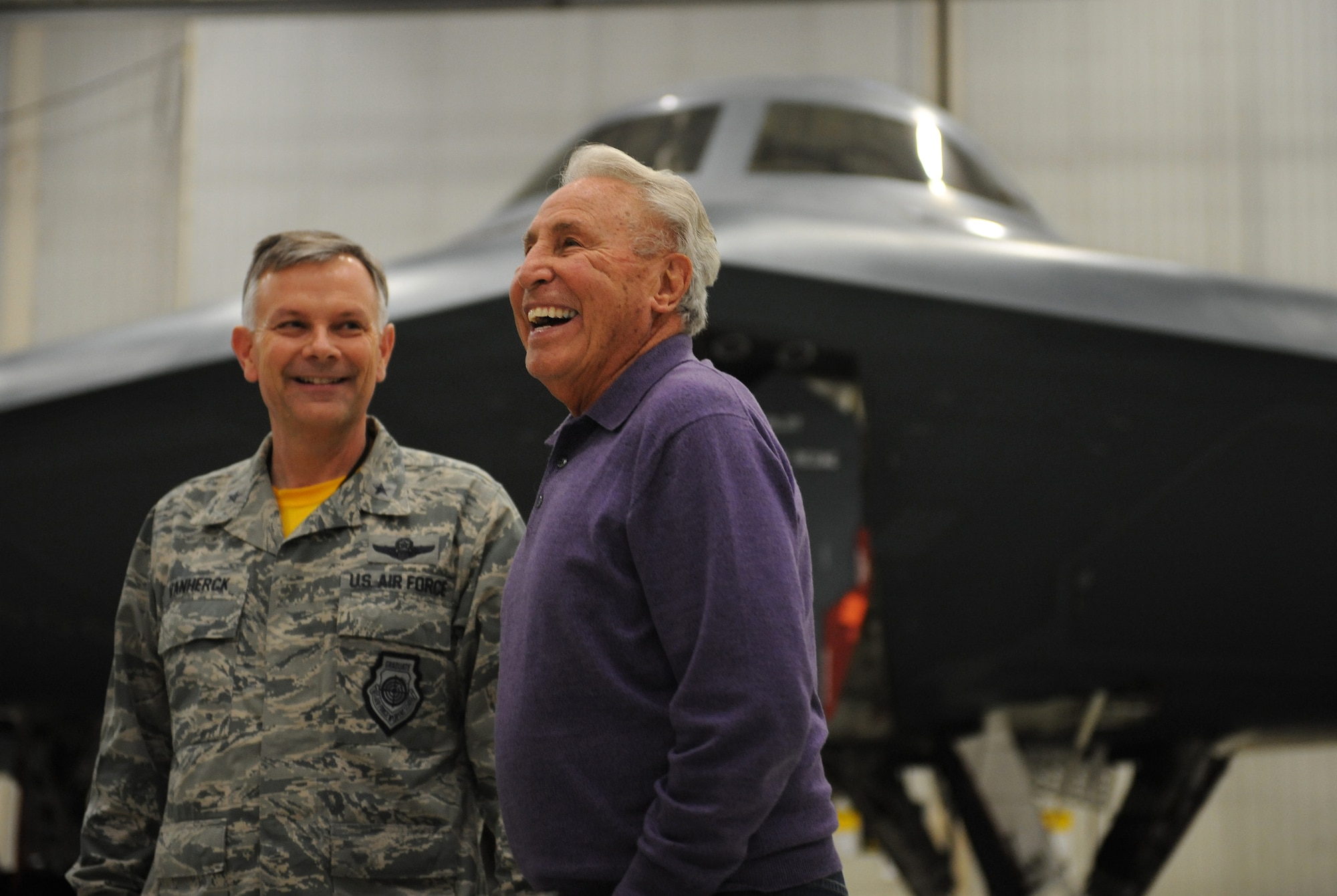 Lee Corso, an ESPN college football analyst, shares a laugh with Brig. Gen. Glen VanHerck, 509th Bomb Wing commander, in front of a B-2 Spirit at Whiteman Air Force Base, Mo., Feb. 6, 2015. Corso was briefed on the B-2’s mission and strategic deterrence capabilities. (U.S. Air Force photo by Airman 1st Class Joel Pfiester/Released)
