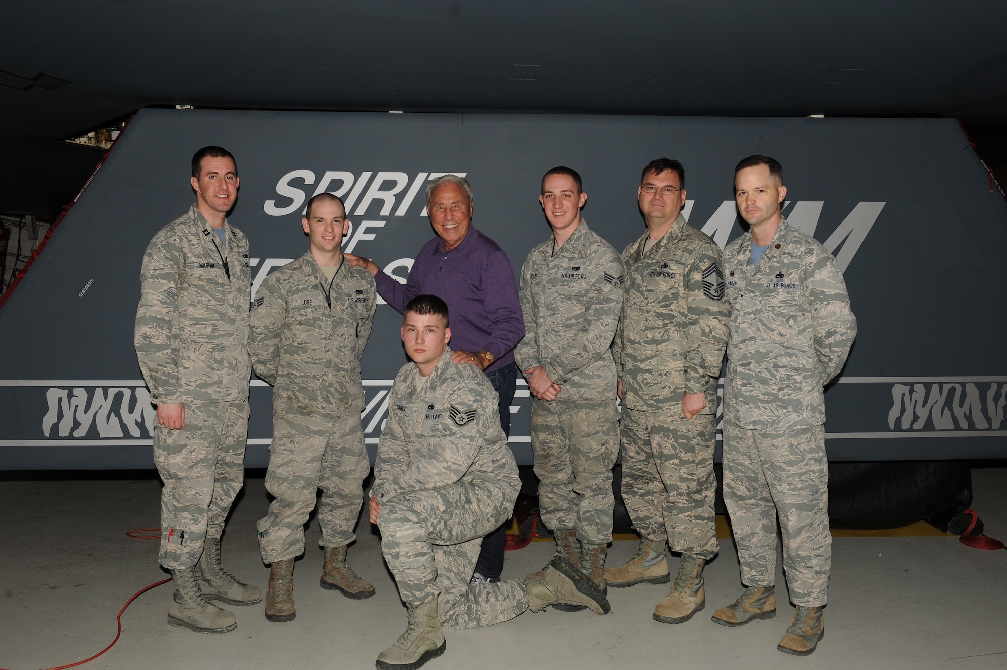 Lee Corso, an ESPN college football analyst, poses by the tail number of the B-2 Spirit of Nebraska with members of the 509th Bomb Wing Aircraft Maintenance Squadron at Whiteman Air Force Base, Mo., Feb. 6, 2015. Corso was briefed on the B-2’s mission and strategic deterrence capabilities. (U.S. Air Force photo by Airman 1st Class Joel Pfiester/Released)
