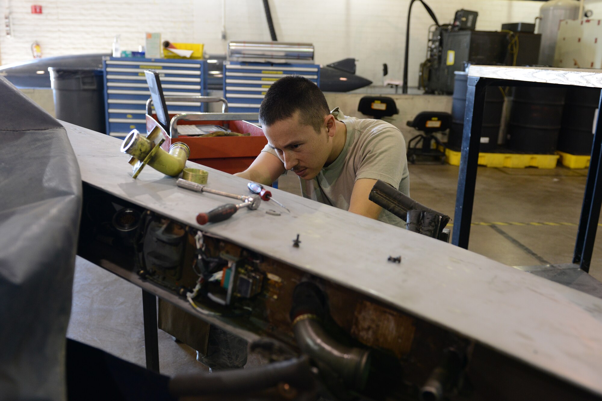 Senior Airman Jonan Torres, 56th CMS aircraft fuels systems journeyman, works on a 370-gallon fuel tank pylon. The pylon connects the fuel tank to the F-16 and has explosive devices built into it to jettison the fuel tank if needed. (U.S. Air Force photo/Senior Airman James Hensley)
