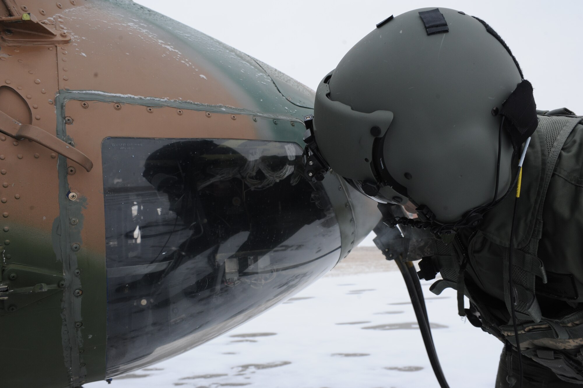 Capt. Jonathan Bonilla, 54th Helicopter Squadron aircraft commander, conducts preflight checks on a UH1-N helicopter on Minot Air Force Base, N.D., Feb. 11, 2015. Bonilla worked alongside his co-pilot and two flight engineers to ensure the aircraft was mission-ready. (U.S. Air Force photos/Senior Airman Stephanie Morris)