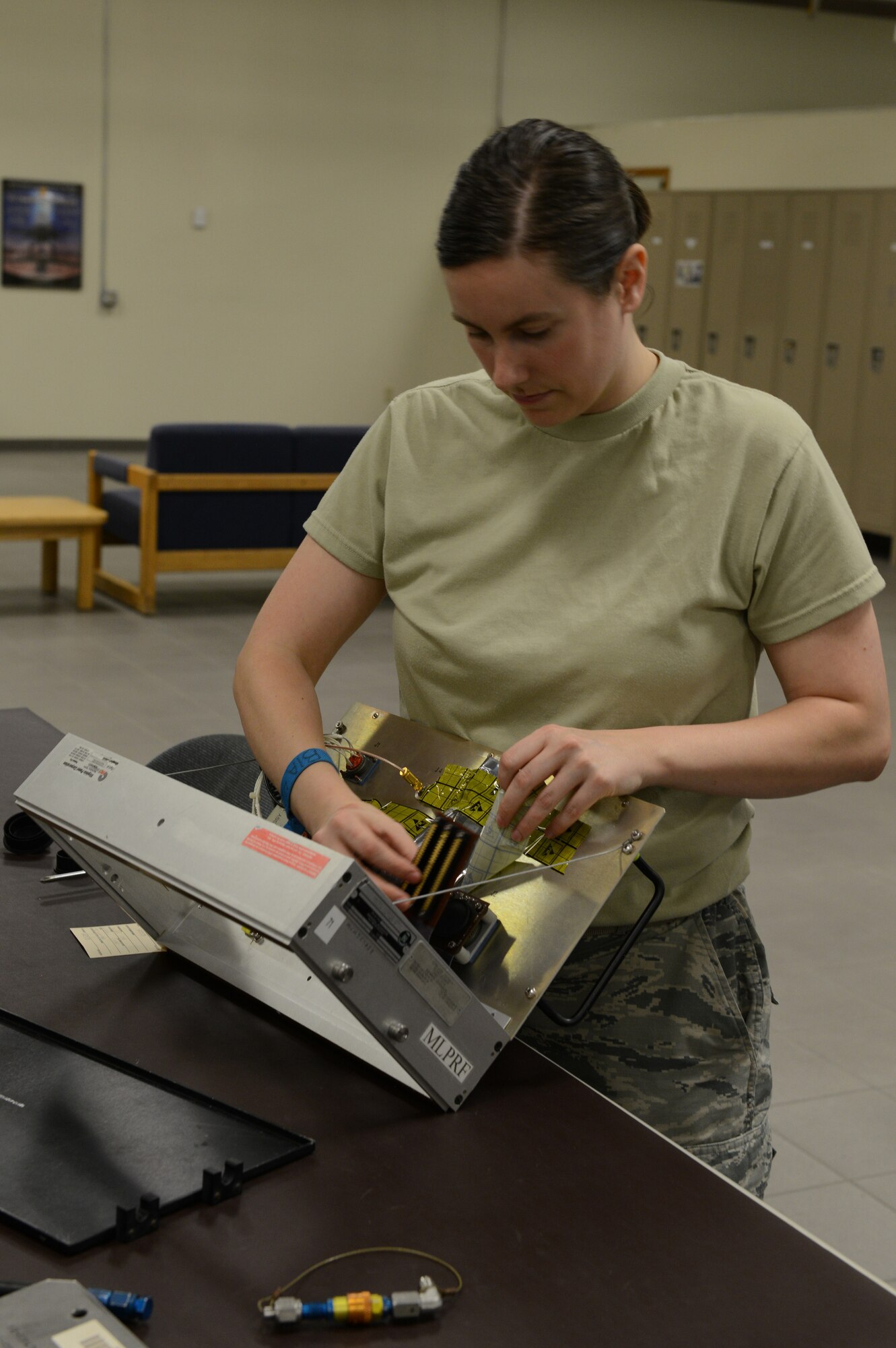 Staff Sgt. Andrea Caldwell, 56th CMS production supervisor, works on a modular low-power radio frequency through the use of an interface test adapter. (U.S. Air Force photo/Senior Airman James Hensley)